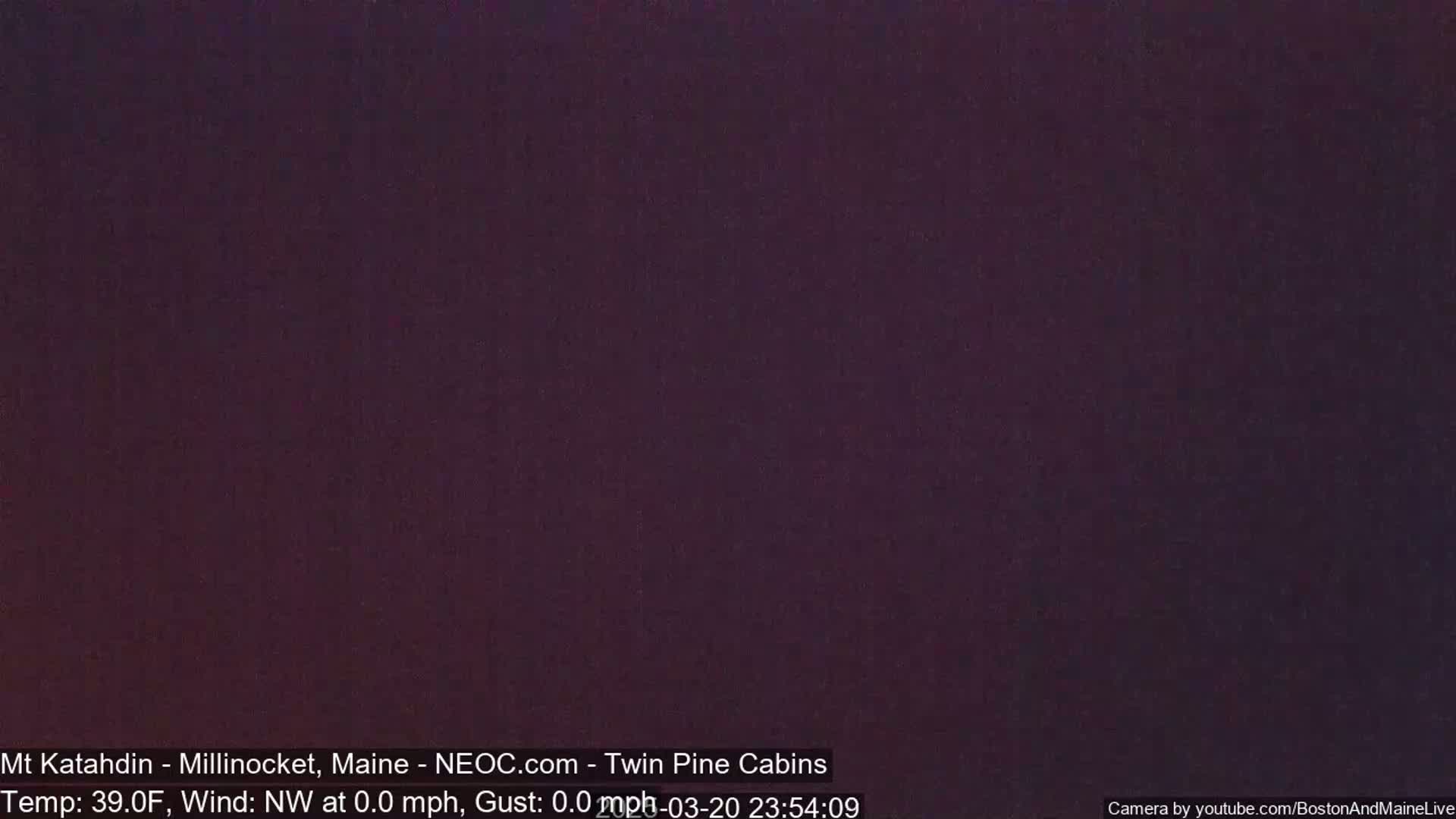 A dark, nighttime image shows a uniformly colored, purplish-black sky.