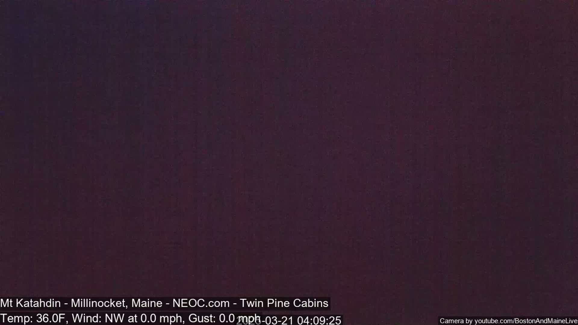 A dark purple image shows a night scene with a temperature of 36°F and a northwest wind at 0.0 mph.