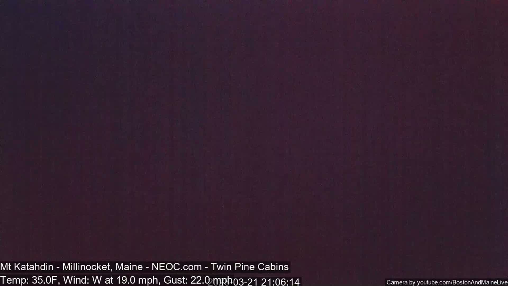 A dark, nighttime image shows a solid, dark purple color.