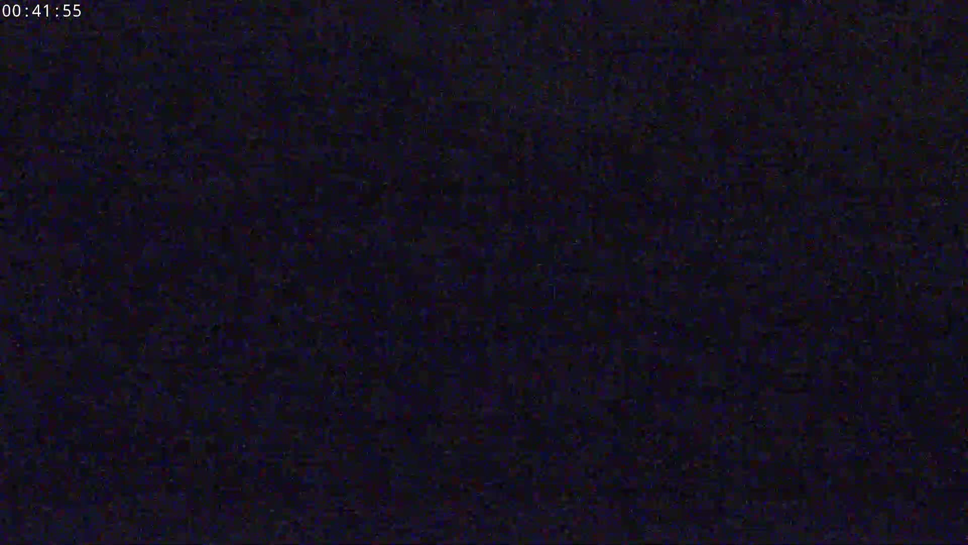 The image shows a dark, grainy screen.