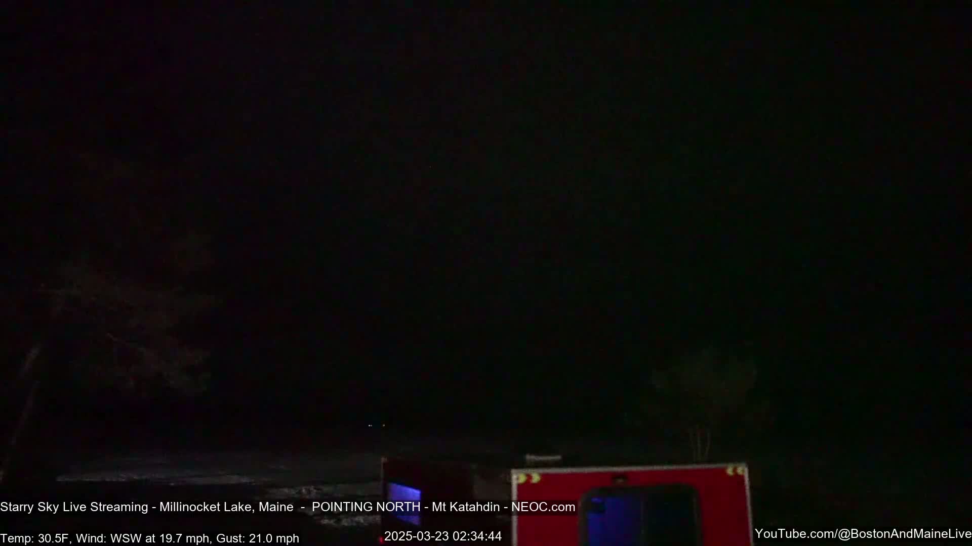 A dark, nighttime scene shows a mostly-clear sky with a few distant lights, under a windy, 30.5°F weather condition.