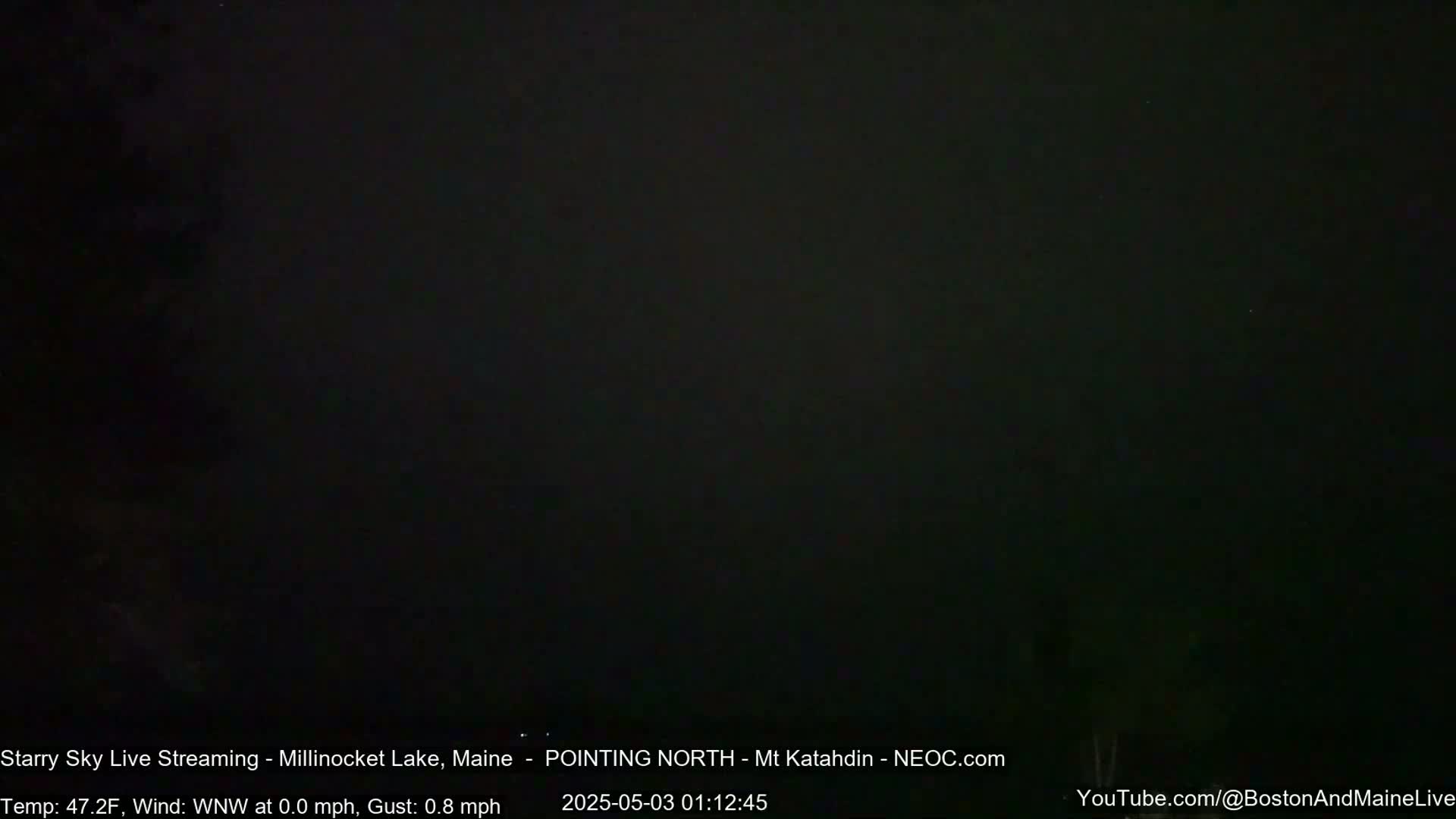A dark, nighttime outdoor scene shows a mostly clear sky with a few faint stars visible.