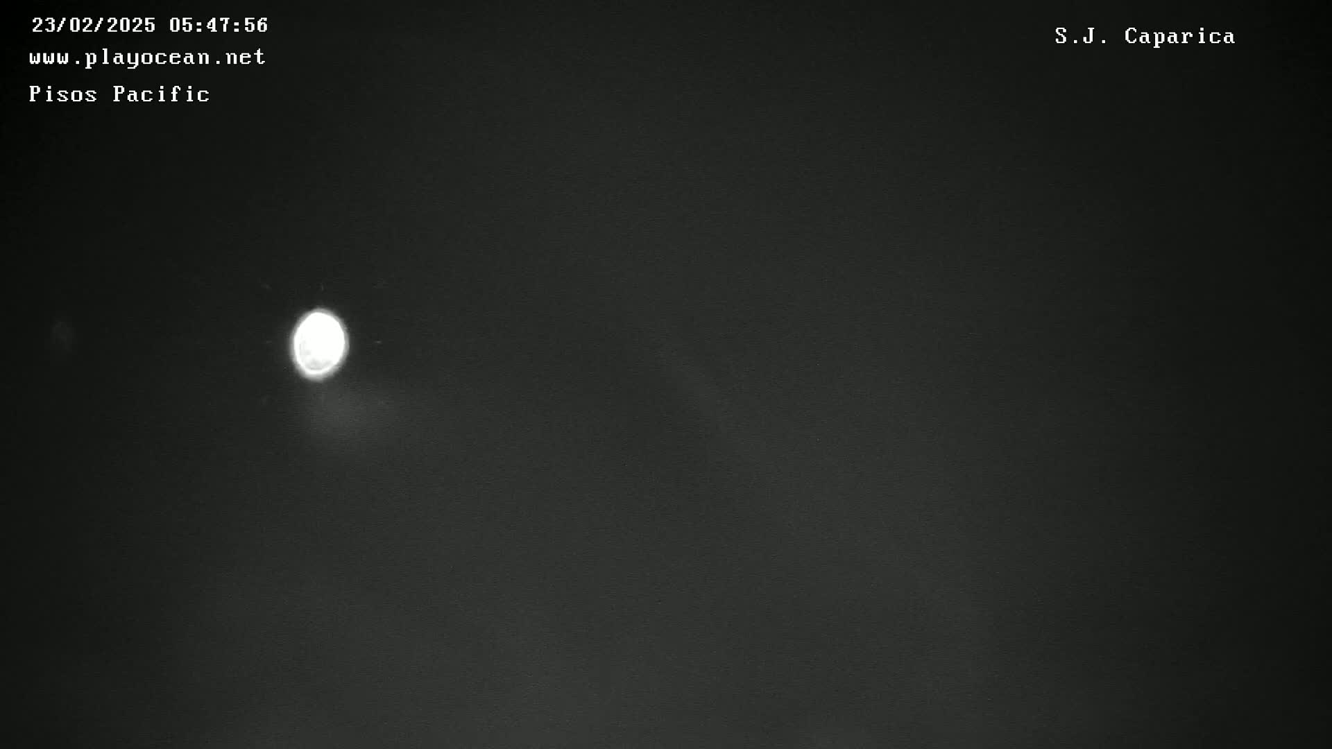 A bright light is visible in the dark night sky.