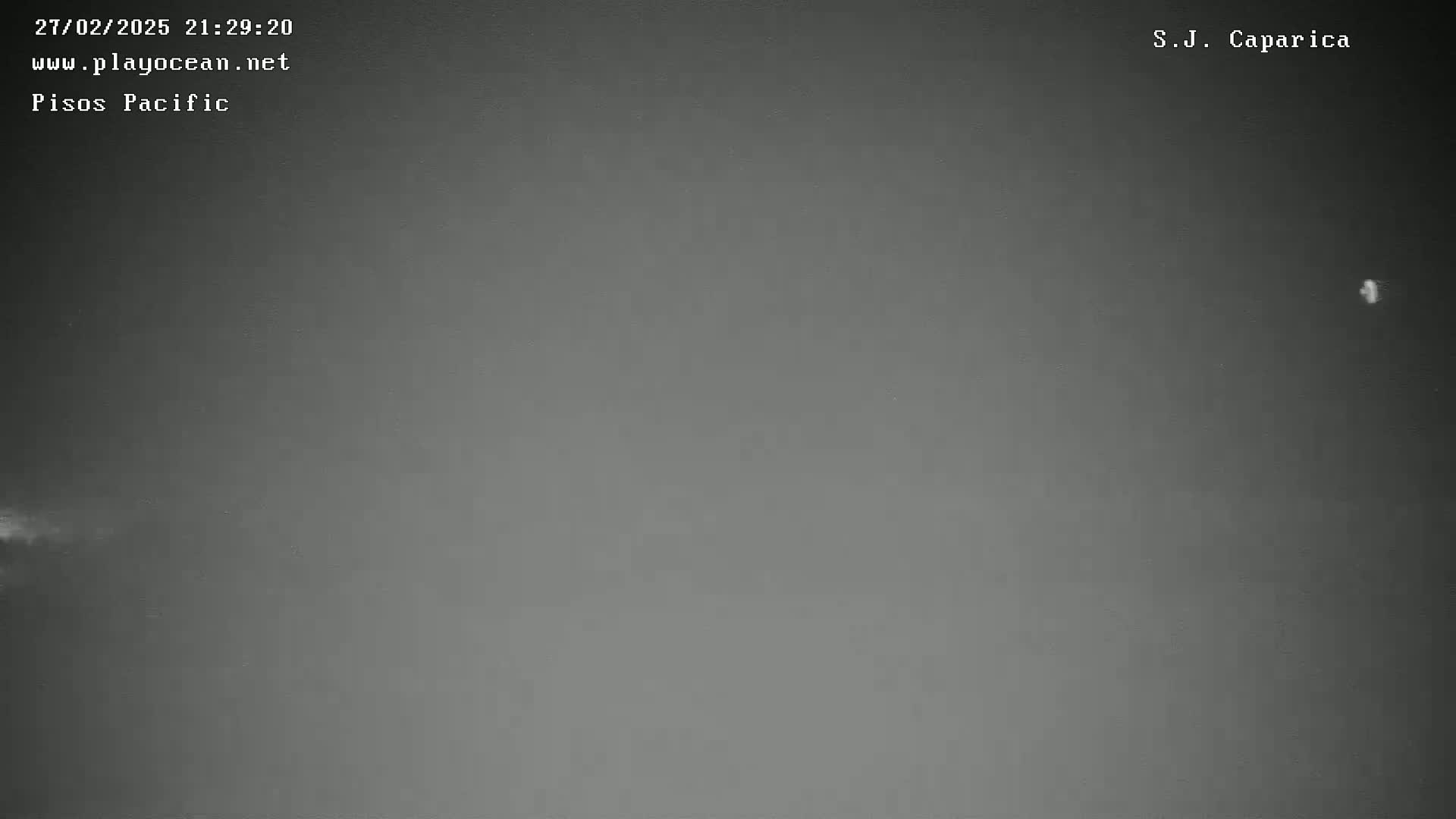 A dark gray, overcast sky is visible at night.