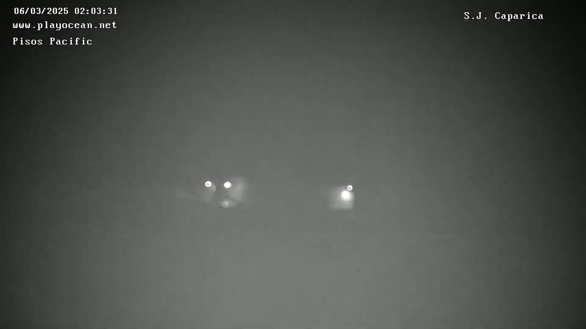 Two distant lights are visible in a dark, nighttime scene.