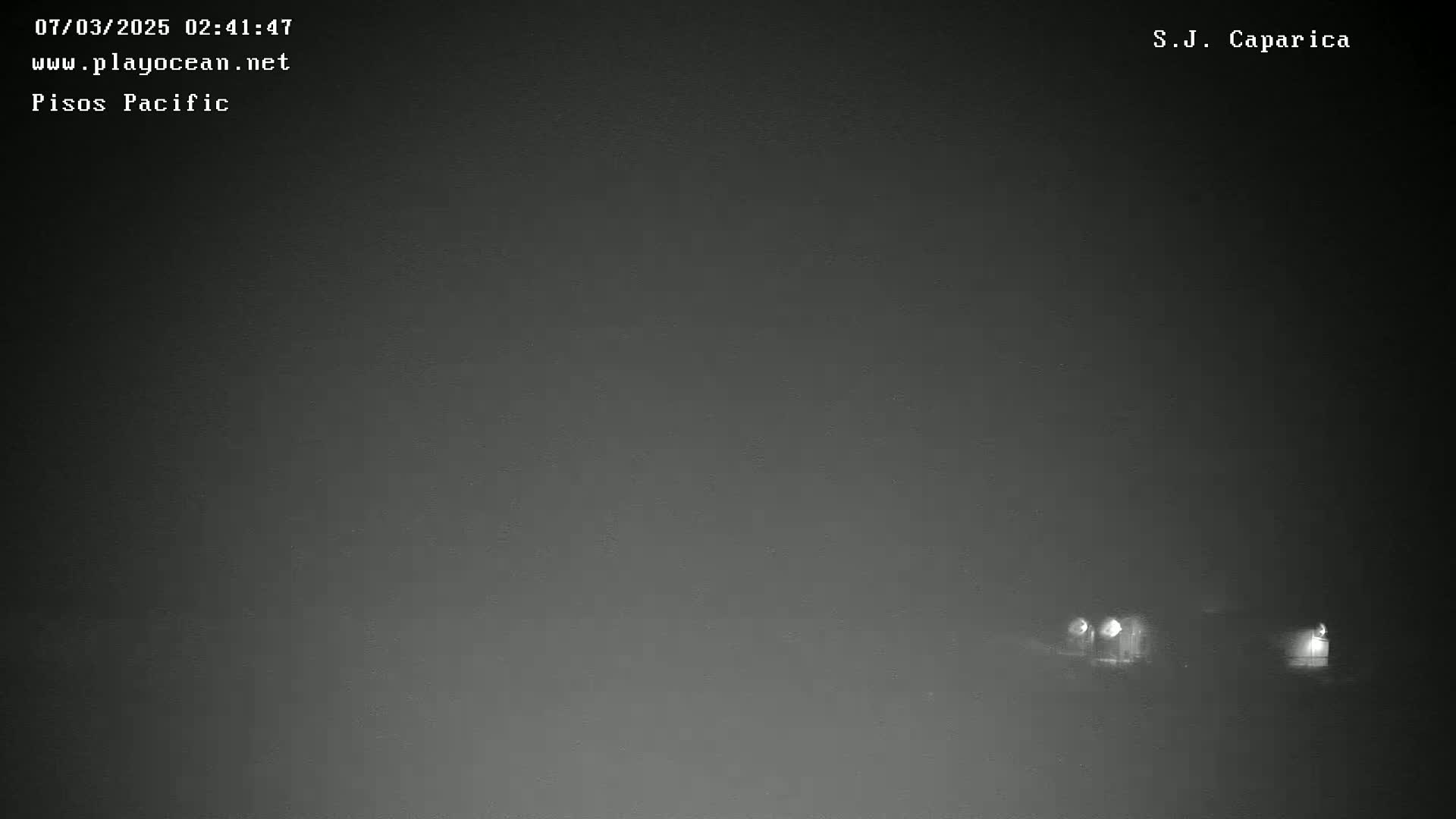 A foggy night scene shows a road with a few distant headlights visible.