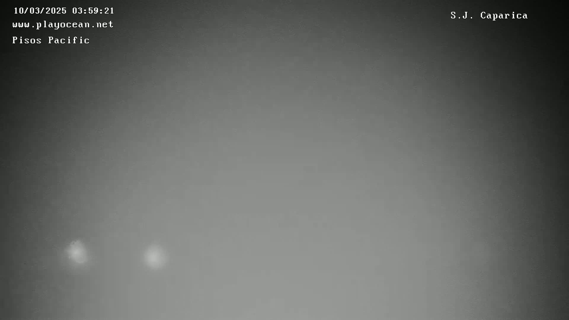 A dark gray, overcast sky shows two faint, small, brighter areas.