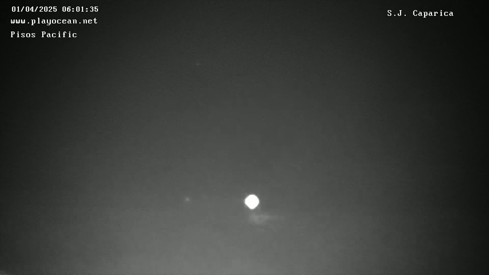 A bright light, possibly the moon, is visible in a dark, night sky.