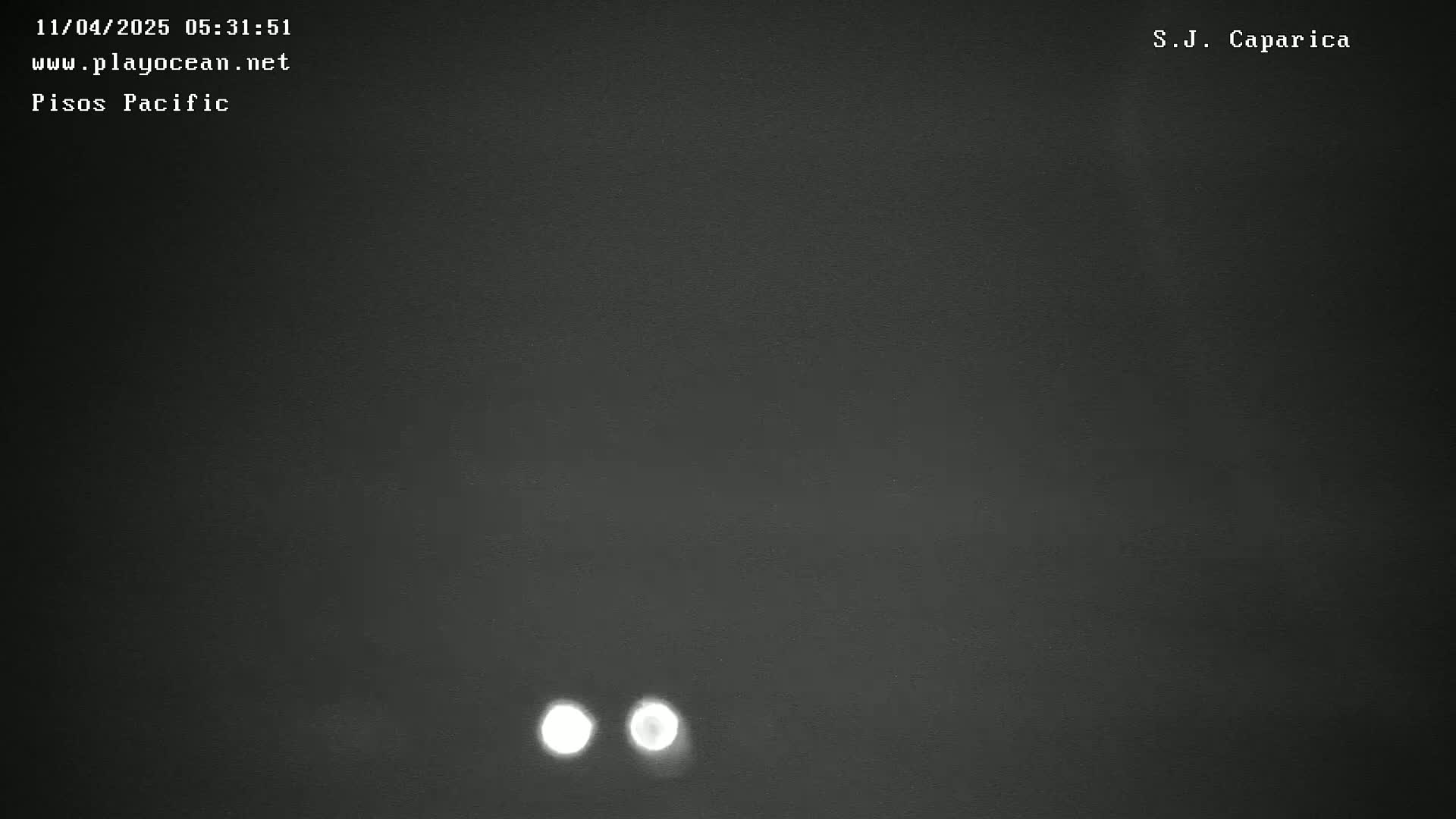 Two blurry lights are visible against a dark, nighttime sky.