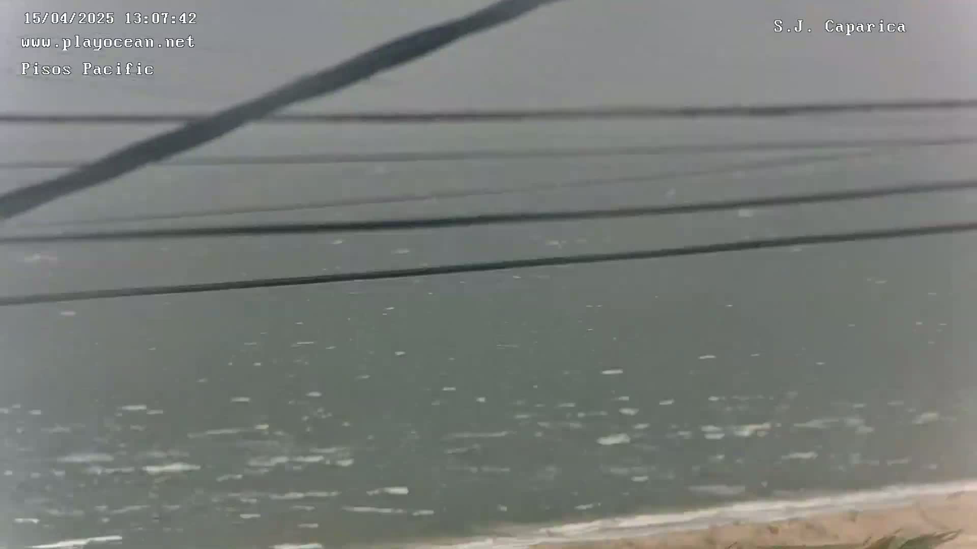 A slightly choppy body of water is seen under an overcast sky.