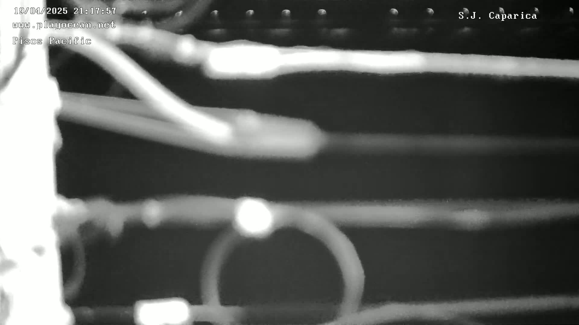 A blurry, grainy, black-and-white image shows several horizontal streaks of light against a dark background.
