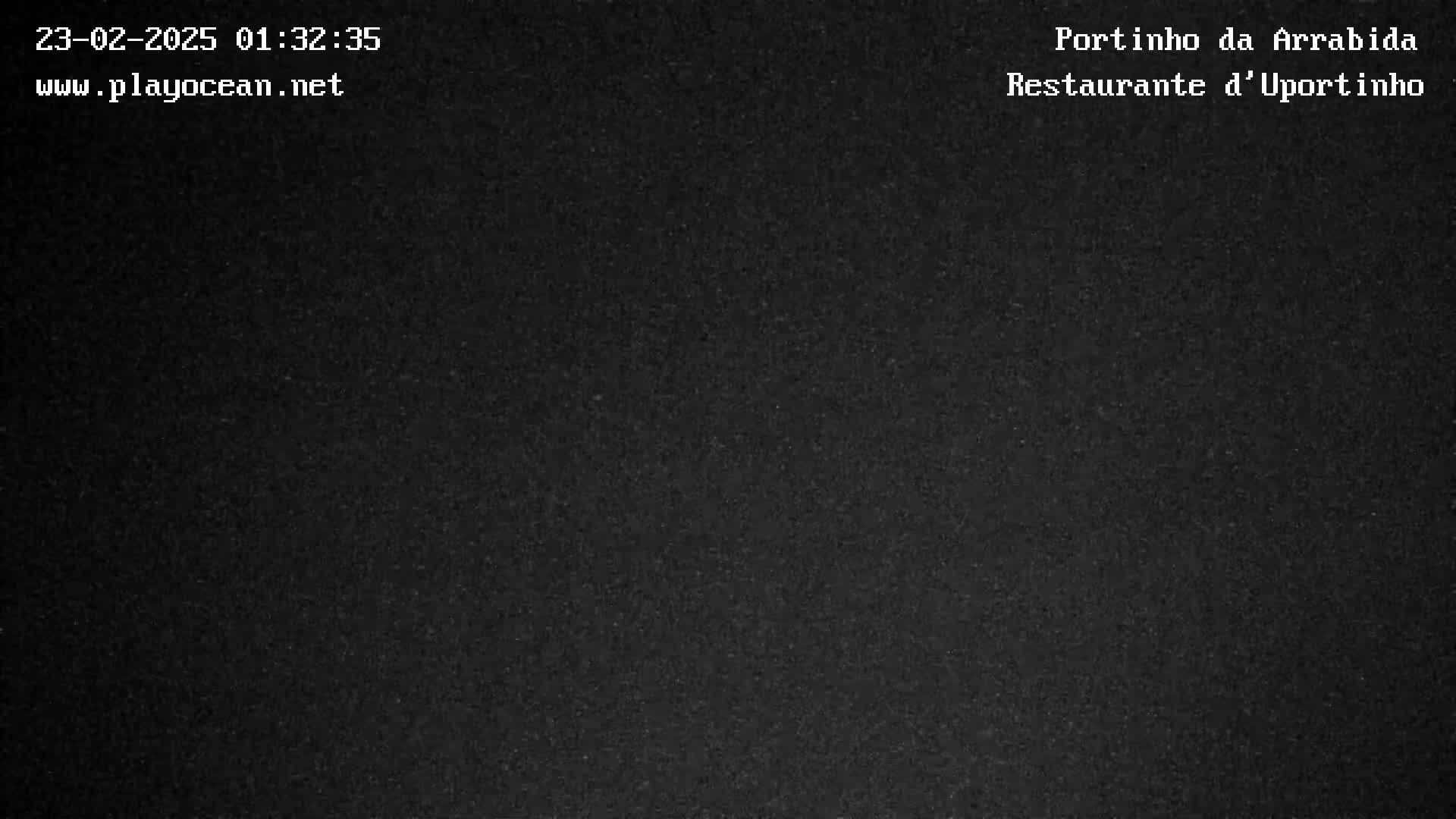 A dark, grainy image shows an indistinguishable, possibly nighttime scene.
