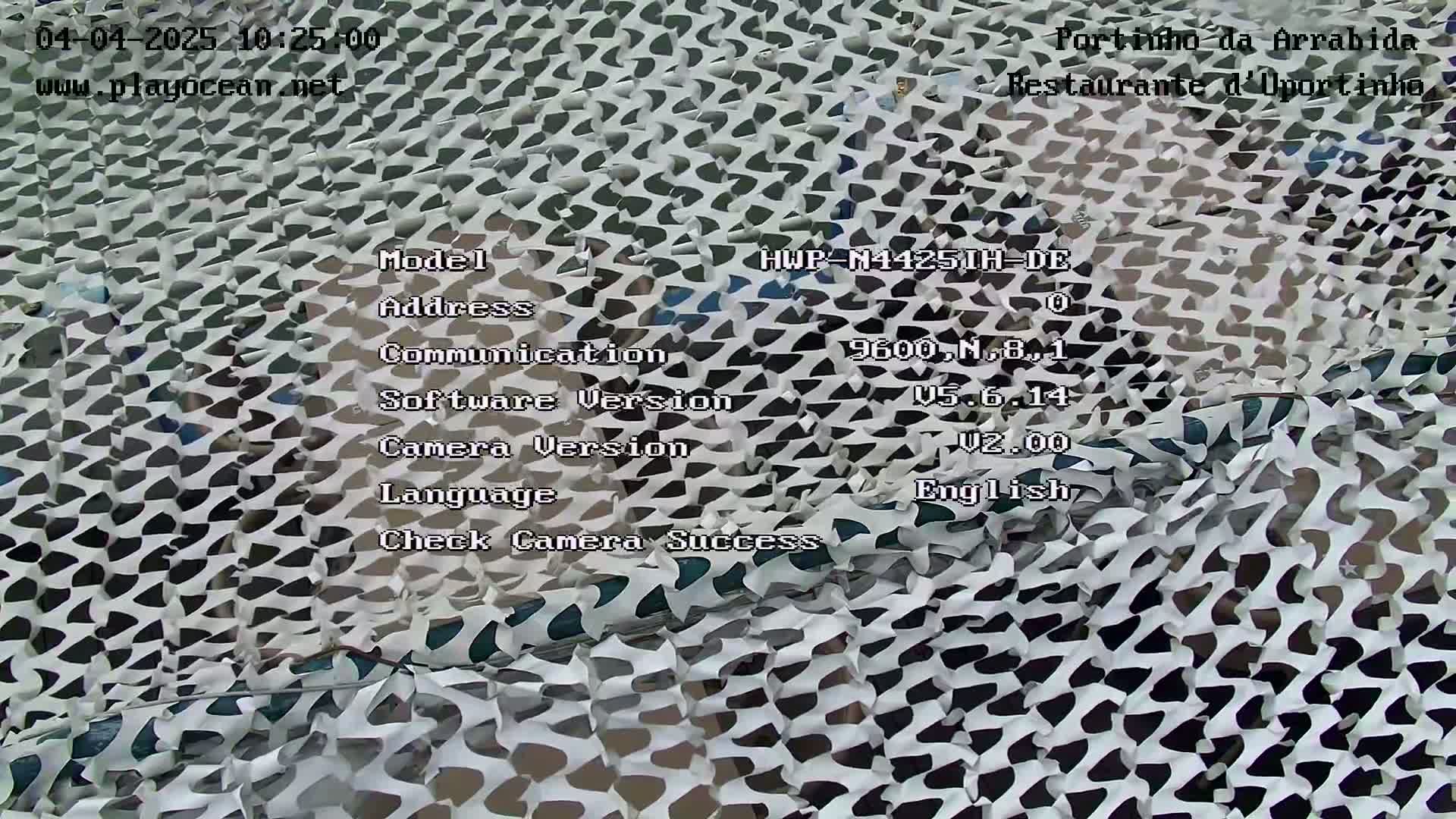 A black and white camouflage net is draped over something.