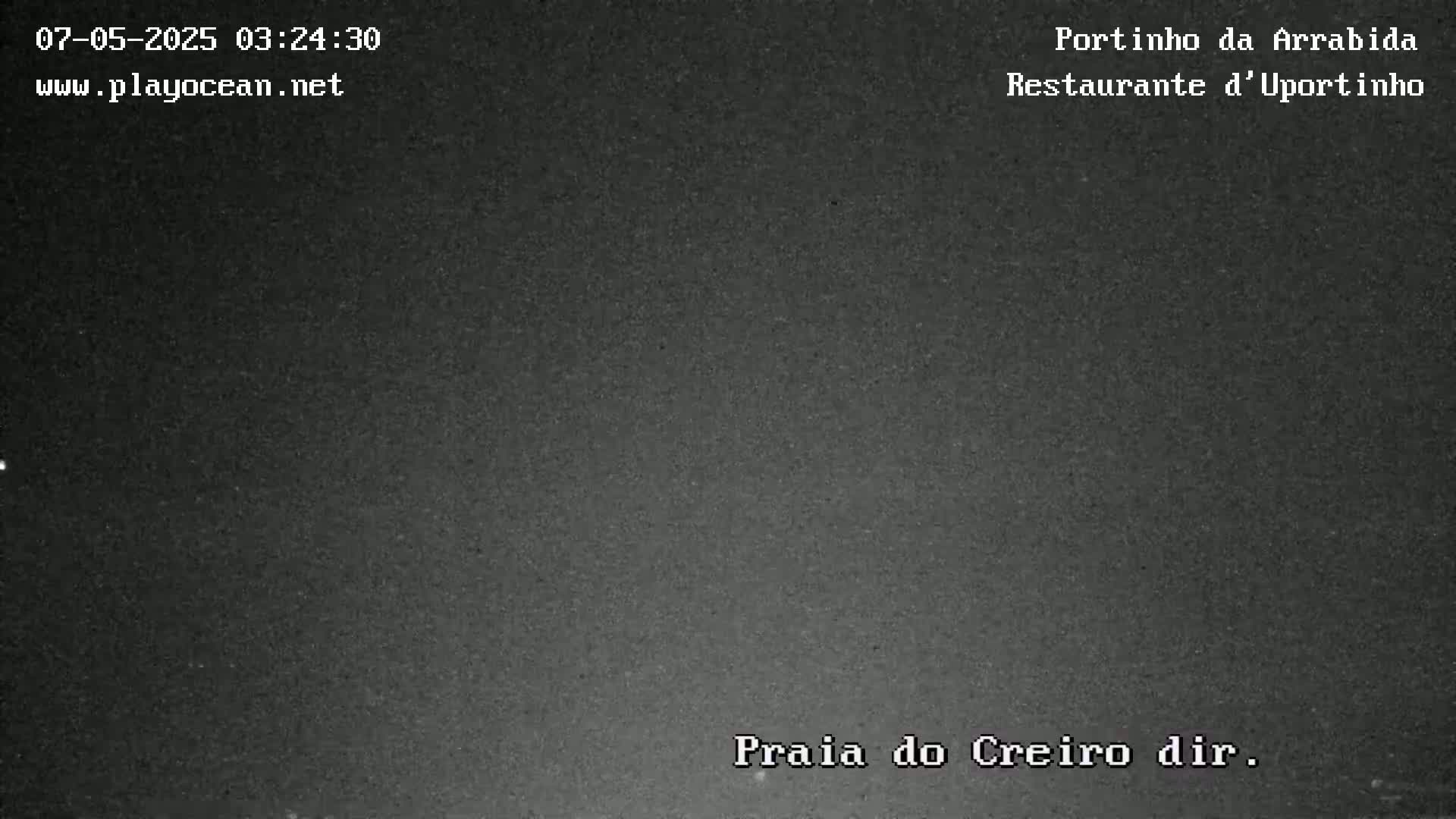 A dark, nighttime image shows a mostly uniform, dark gray surface.