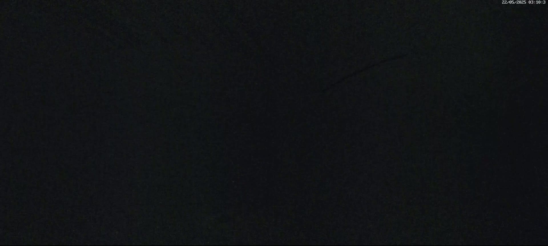The image shows a completely dark, grainy surface.