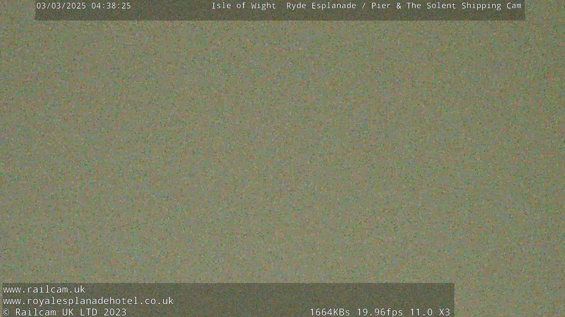 A blurry, muted green image shows no discernible objects or scene.