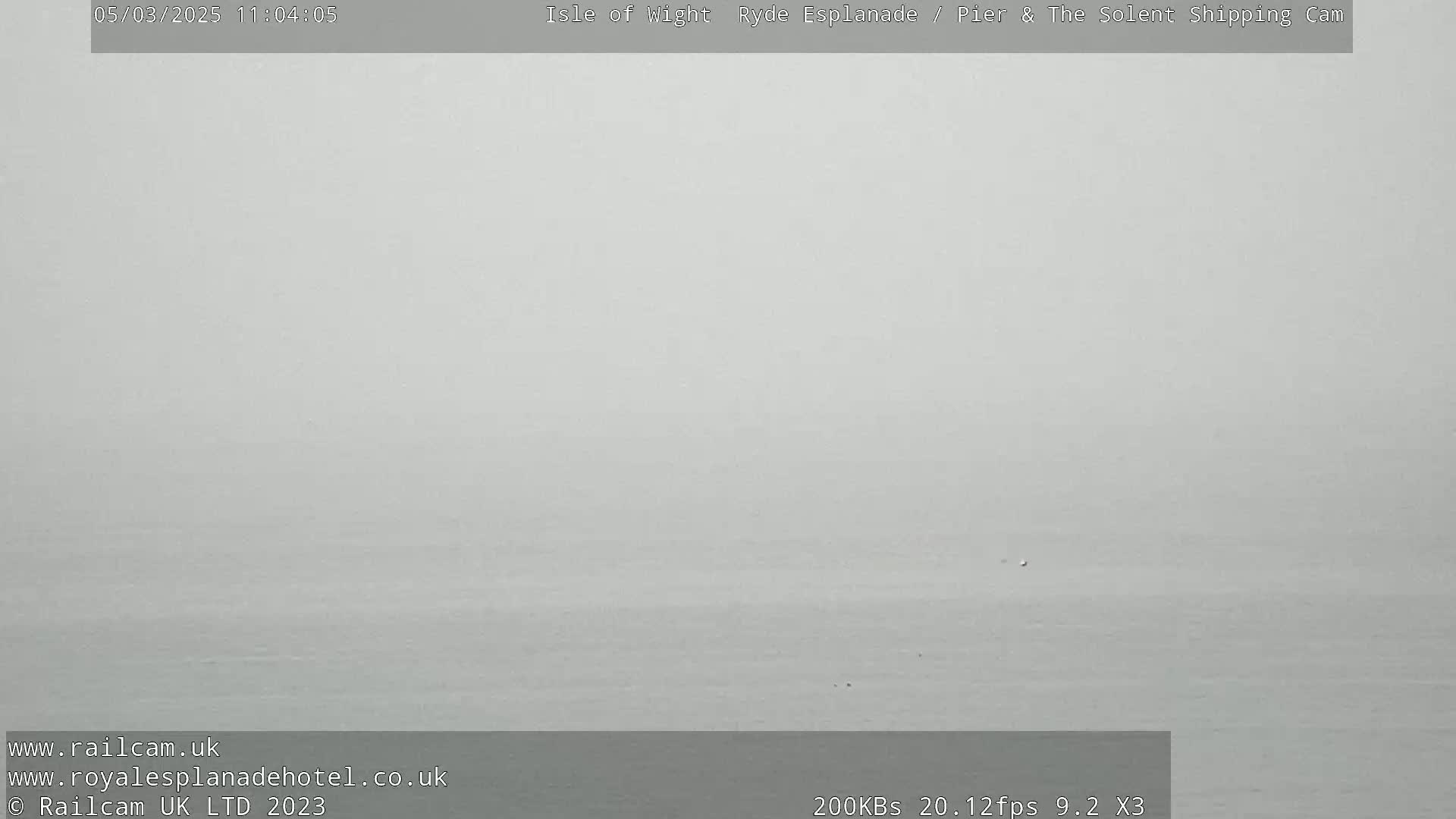 A mostly featureless, gray body of water is visible under an overcast sky.
