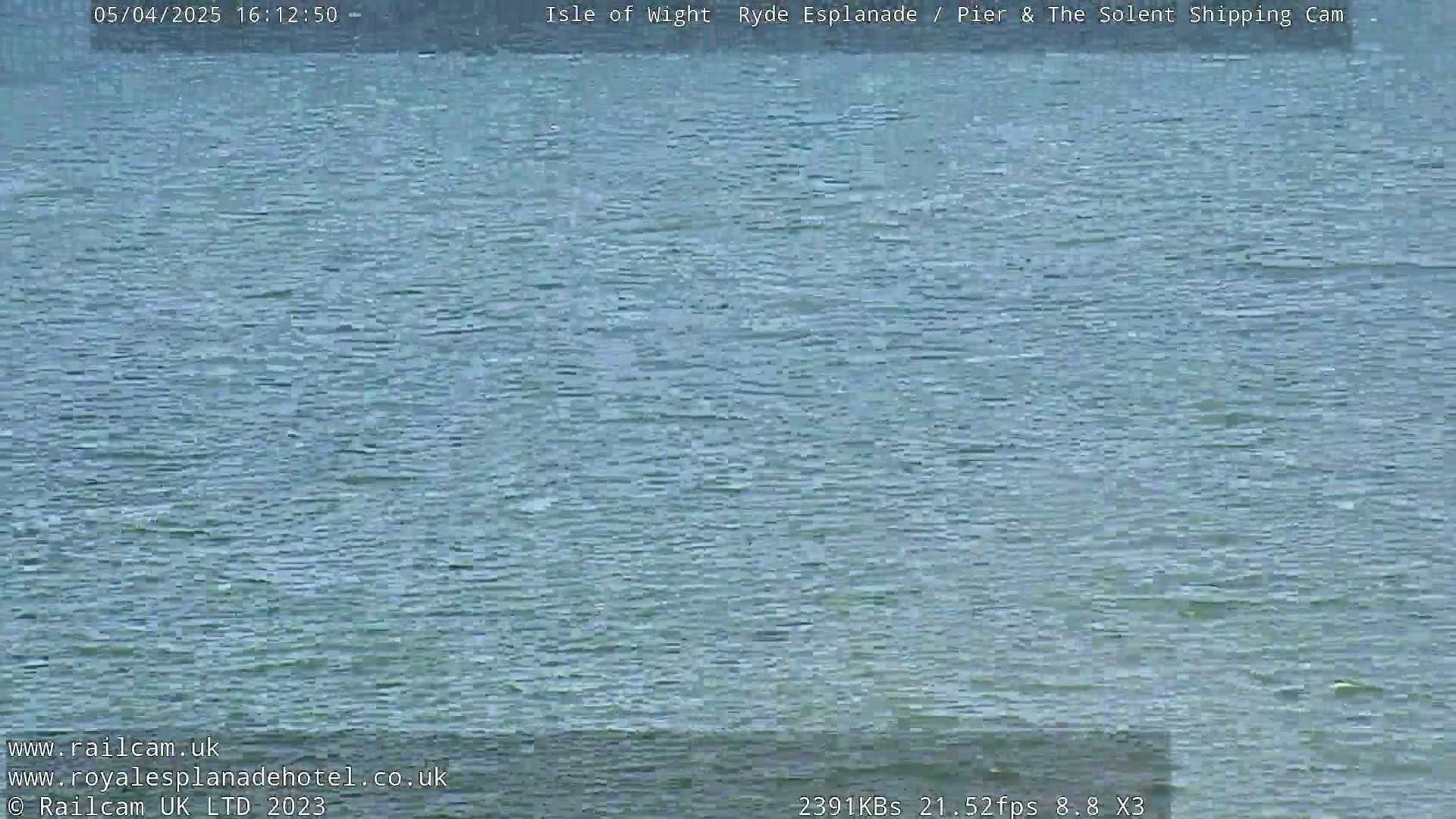A mostly calm body of water is shown, with small ripples on the surface.
