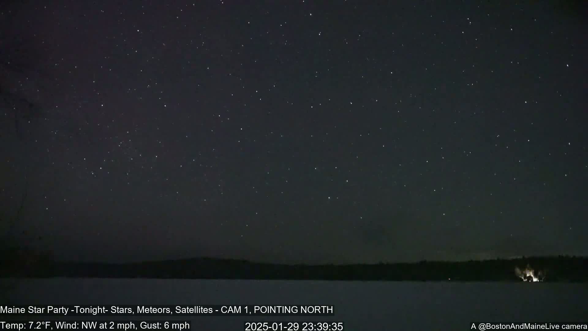A clear night sky full of stars is visible over a snow-covered landscape, with a light northwest wind.