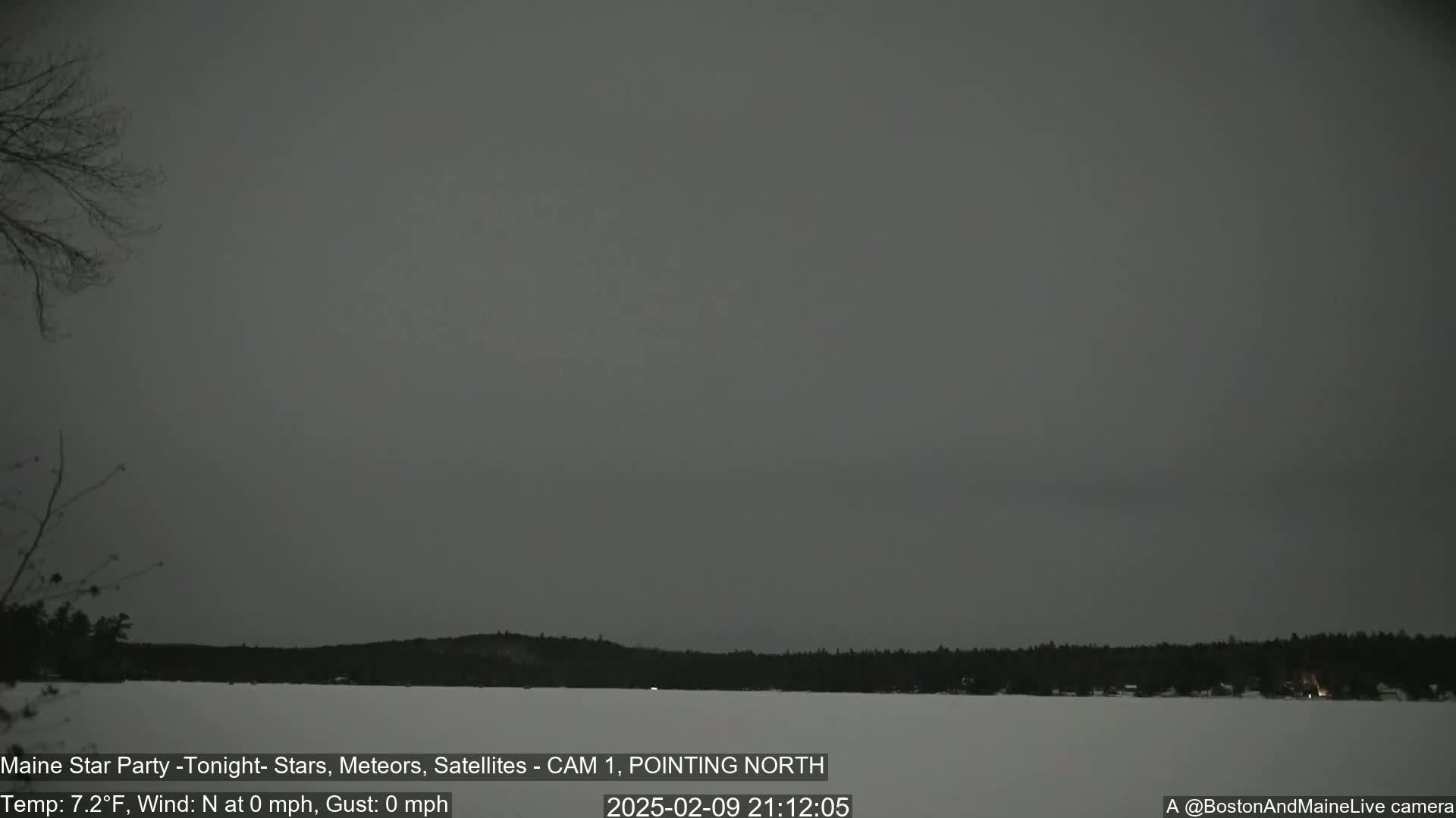 A snow-covered landscape with a dark, overcast sky is visible at night.
