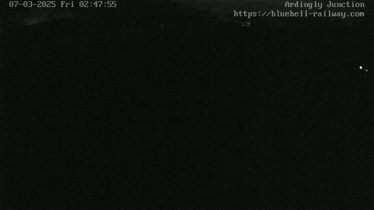 A dark, nighttime image shows a mostly black scene with minimal illumination.