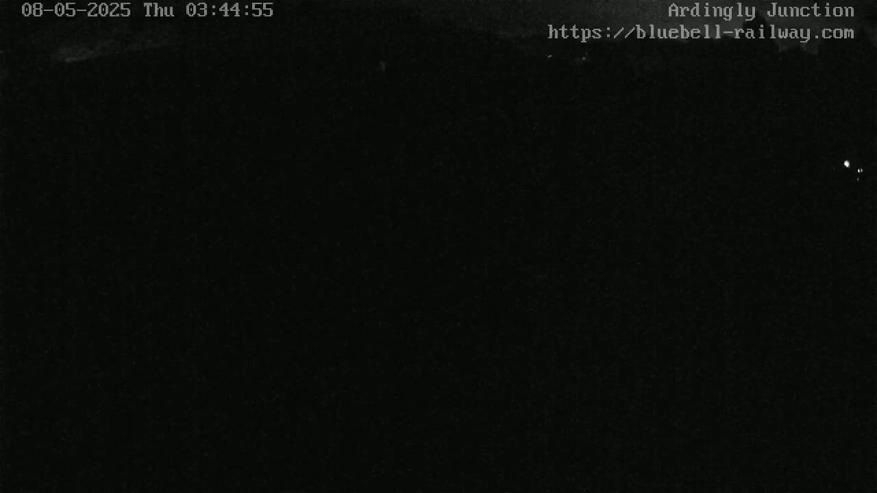 A nighttime, dark outdoor scene with minimal visibility.