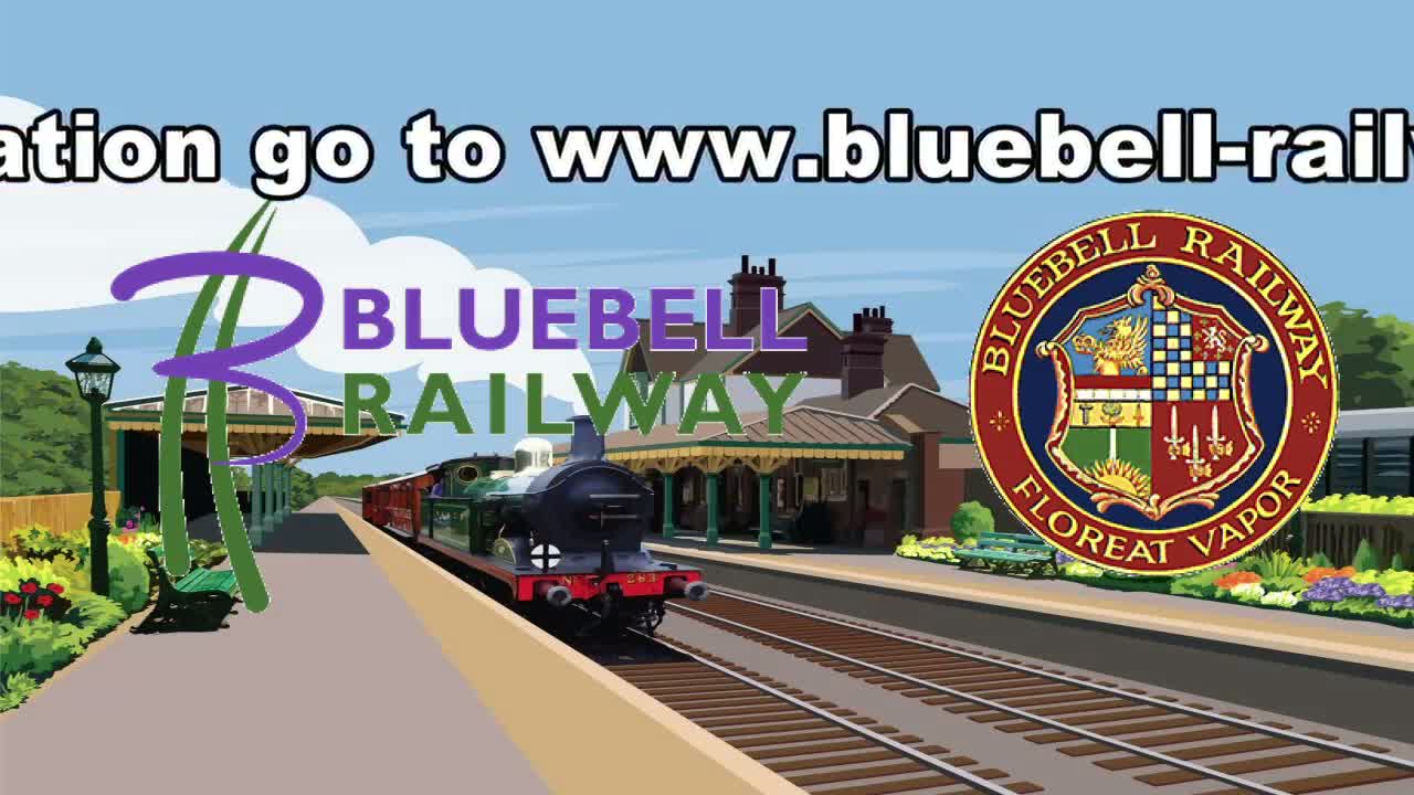 A steam train pulls into a quaint train station on a sunny day.