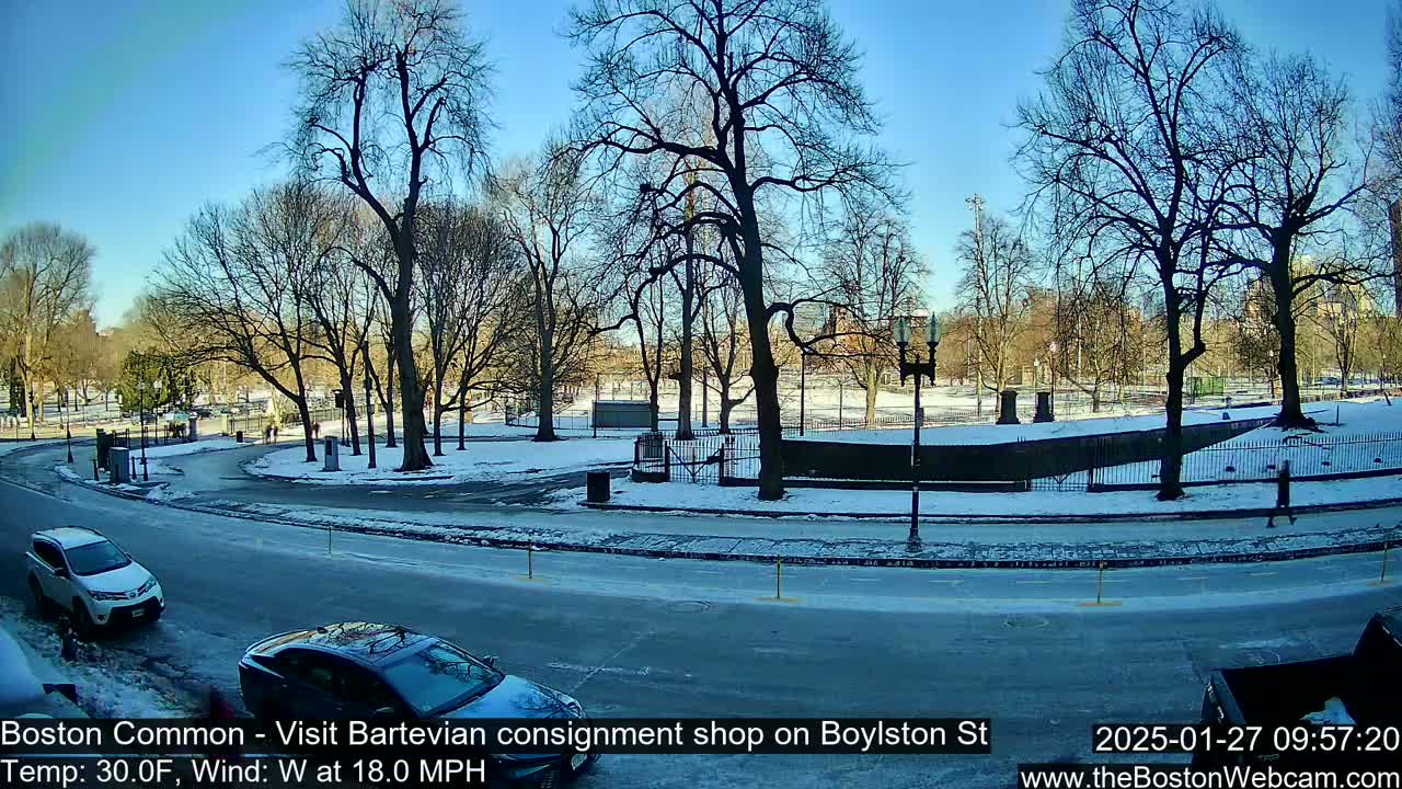 A snow-covered park with bare trees and a street with cars is visible under a clear blue sky, with a westerly wind at 18 mph and a temperature of 30 degrees Fahrenheit.