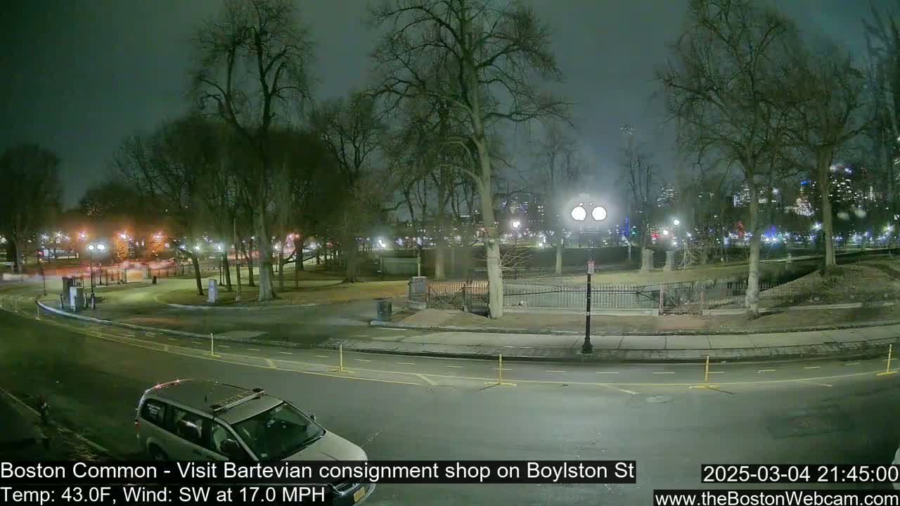 A nighttime view of a park with trees and a roadway, under a dark sky with a southwest wind of 17 mph and a temperature of 43°F.