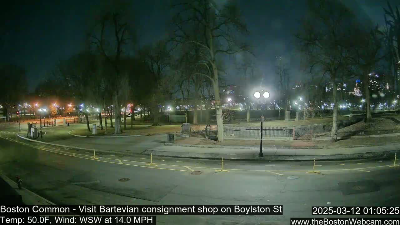 A nighttime view of a park with paved roads and walkways, under a dark sky with a WSW wind at 14.0 mph.