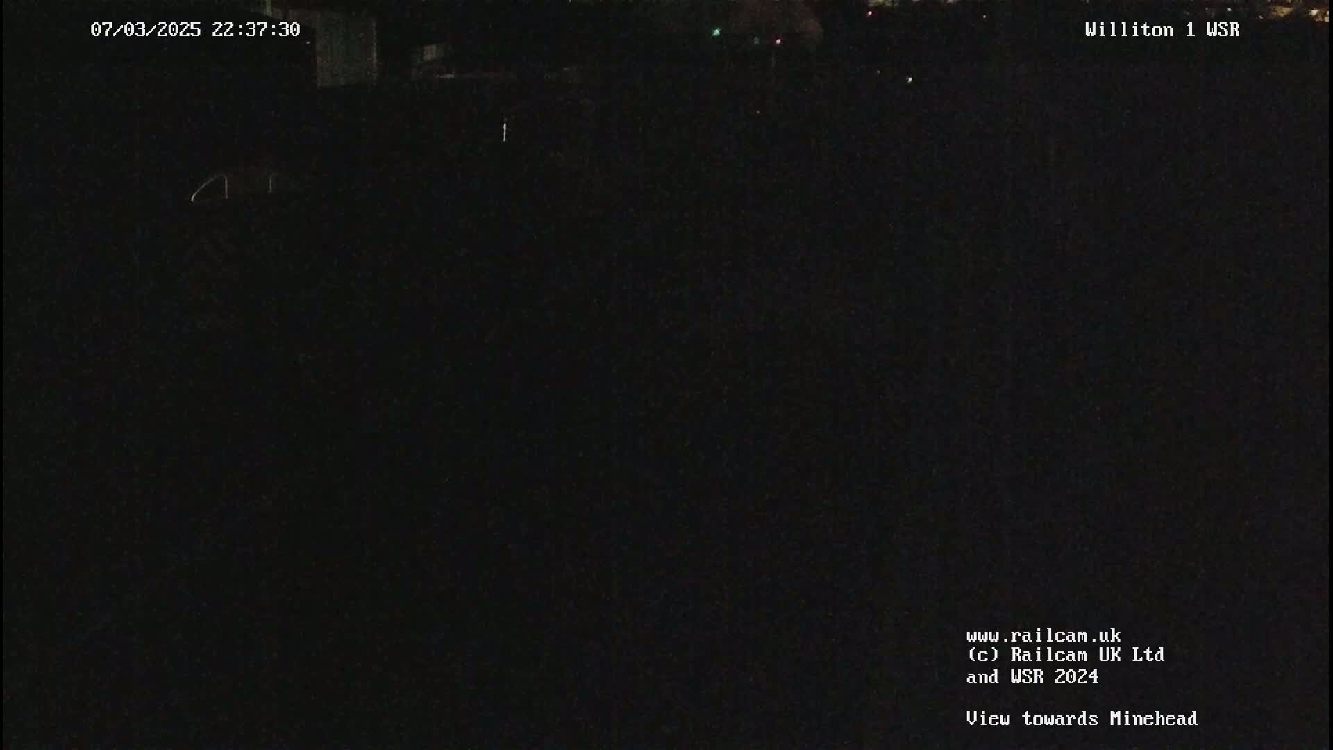 A dark, nighttime view of an empty field.