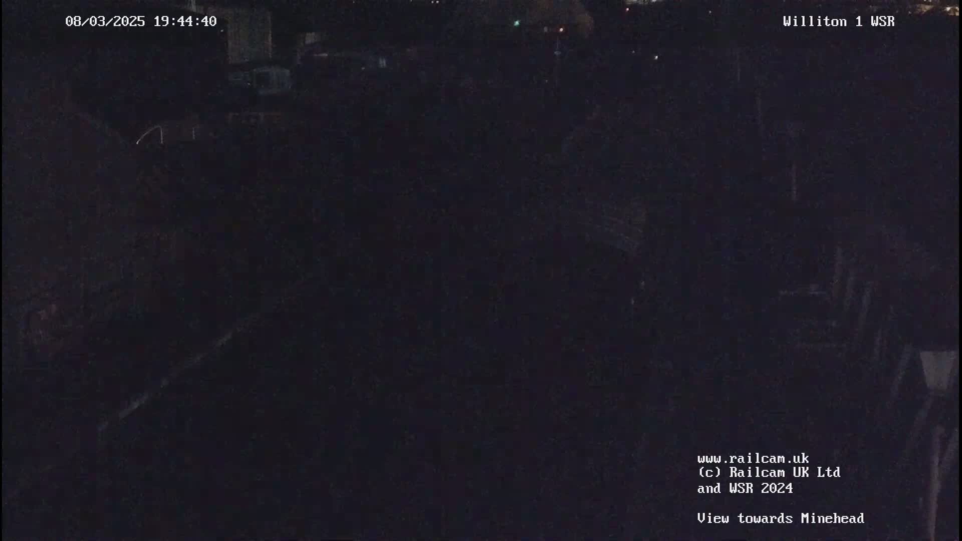 A dark, nighttime view of an indistinct outdoor scene.