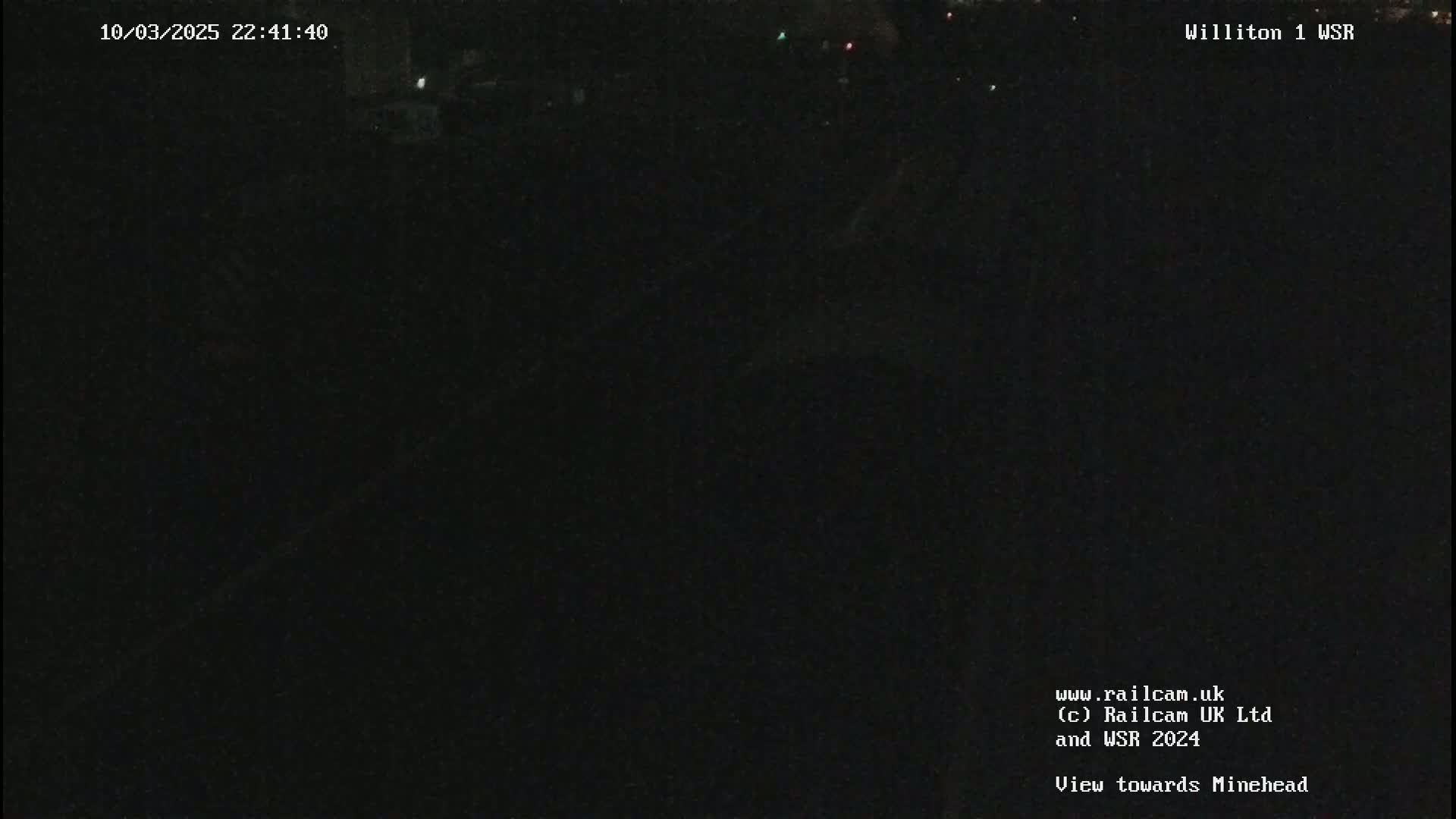 A dark, nighttime view of an indistinct landscape.