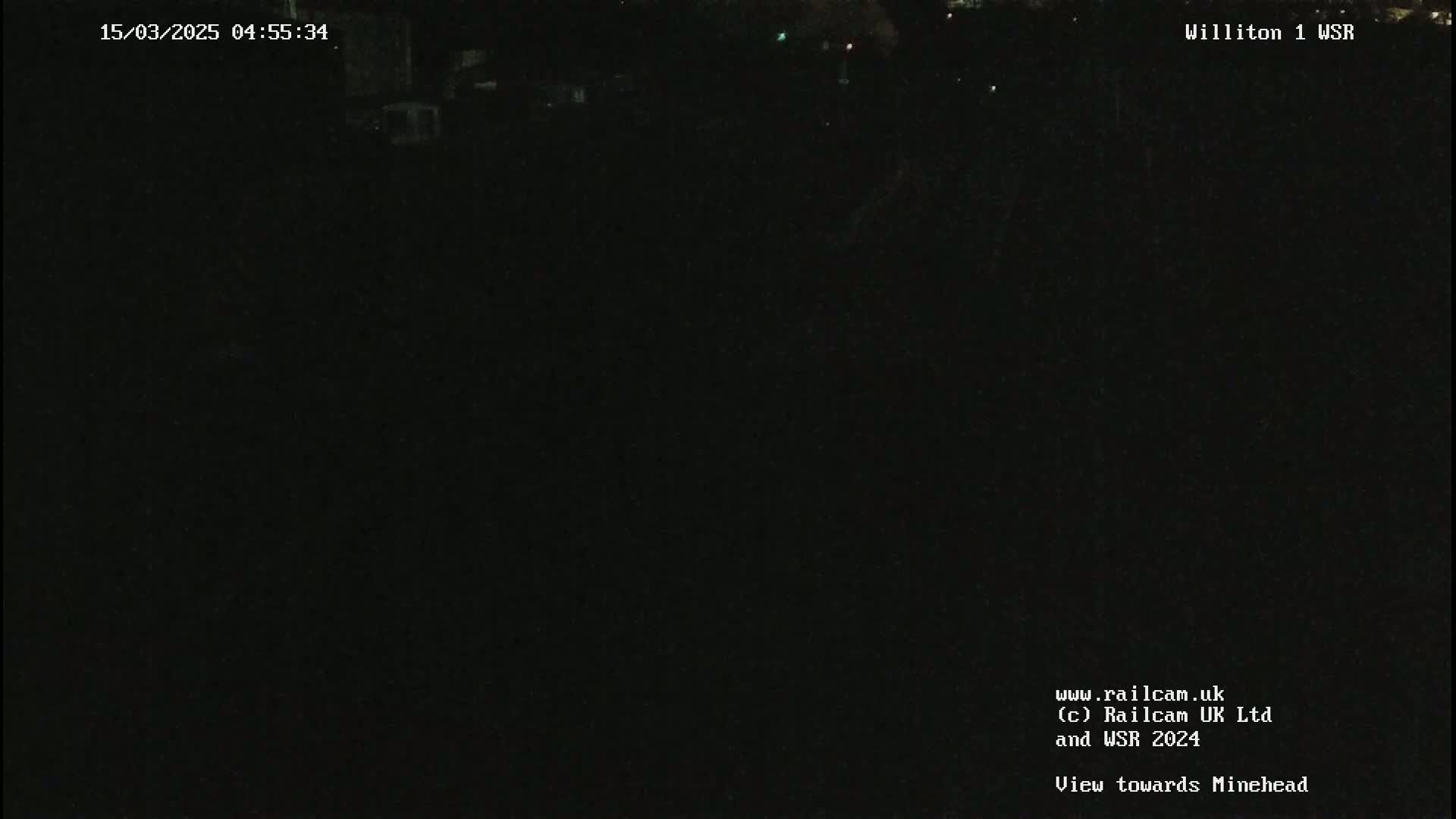 A dark, nighttime view of a seemingly empty field.