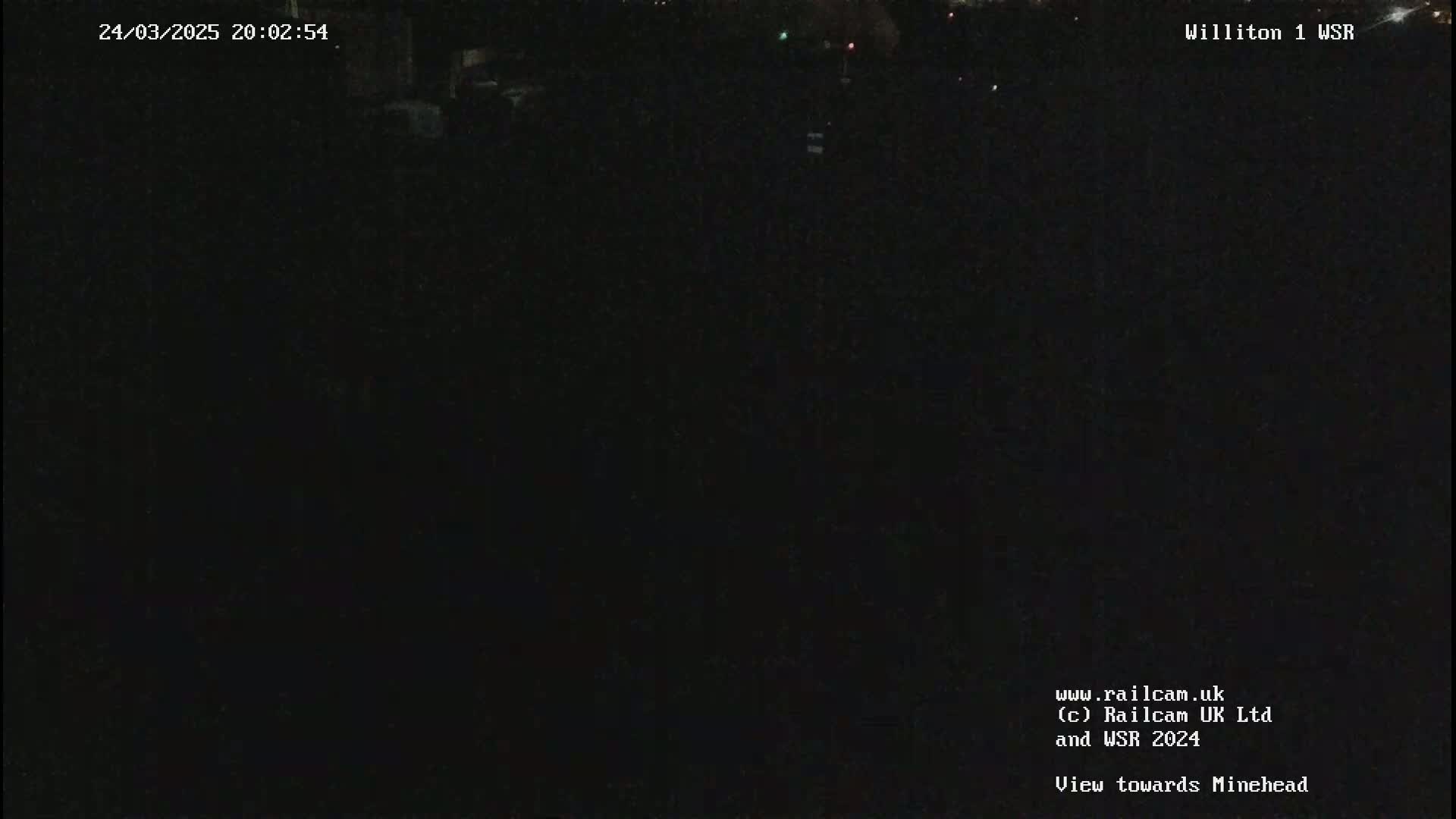 A nighttime view of a dark, seemingly empty area.