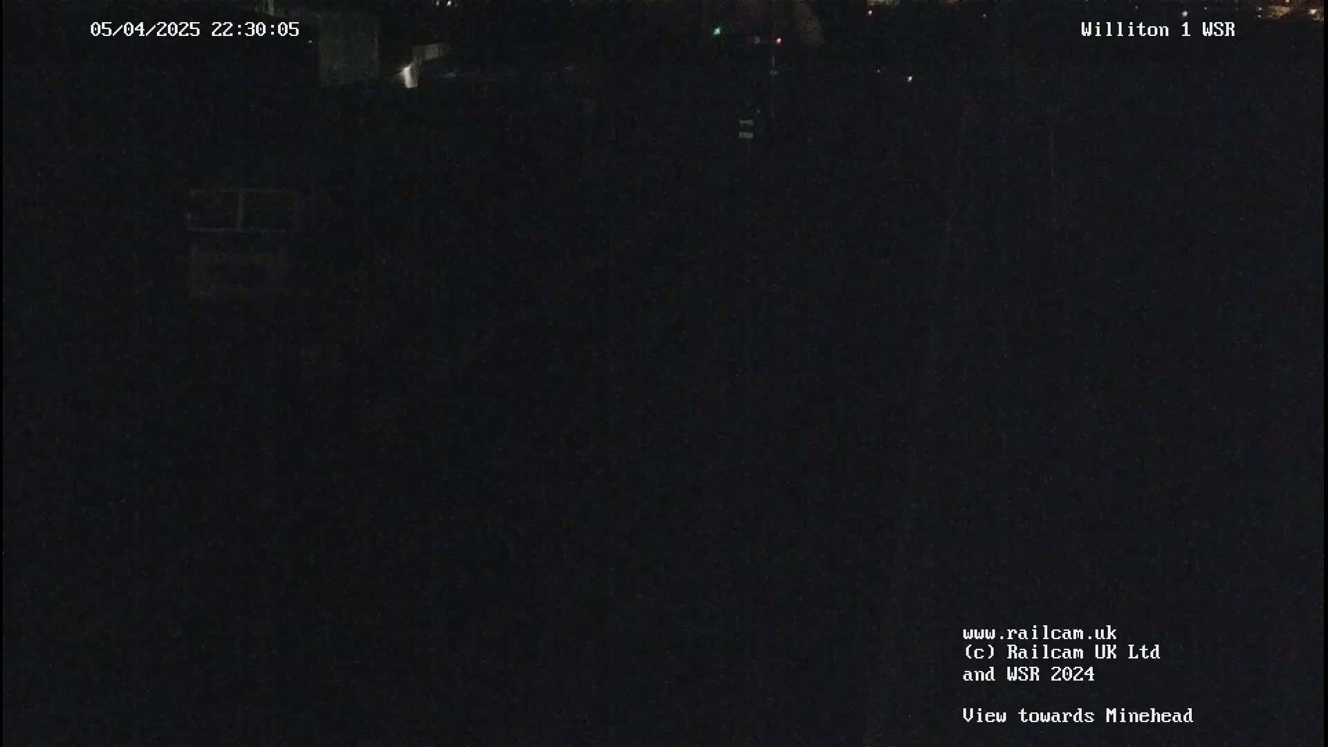 A dark, nighttime view of a mostly obscured landscape.