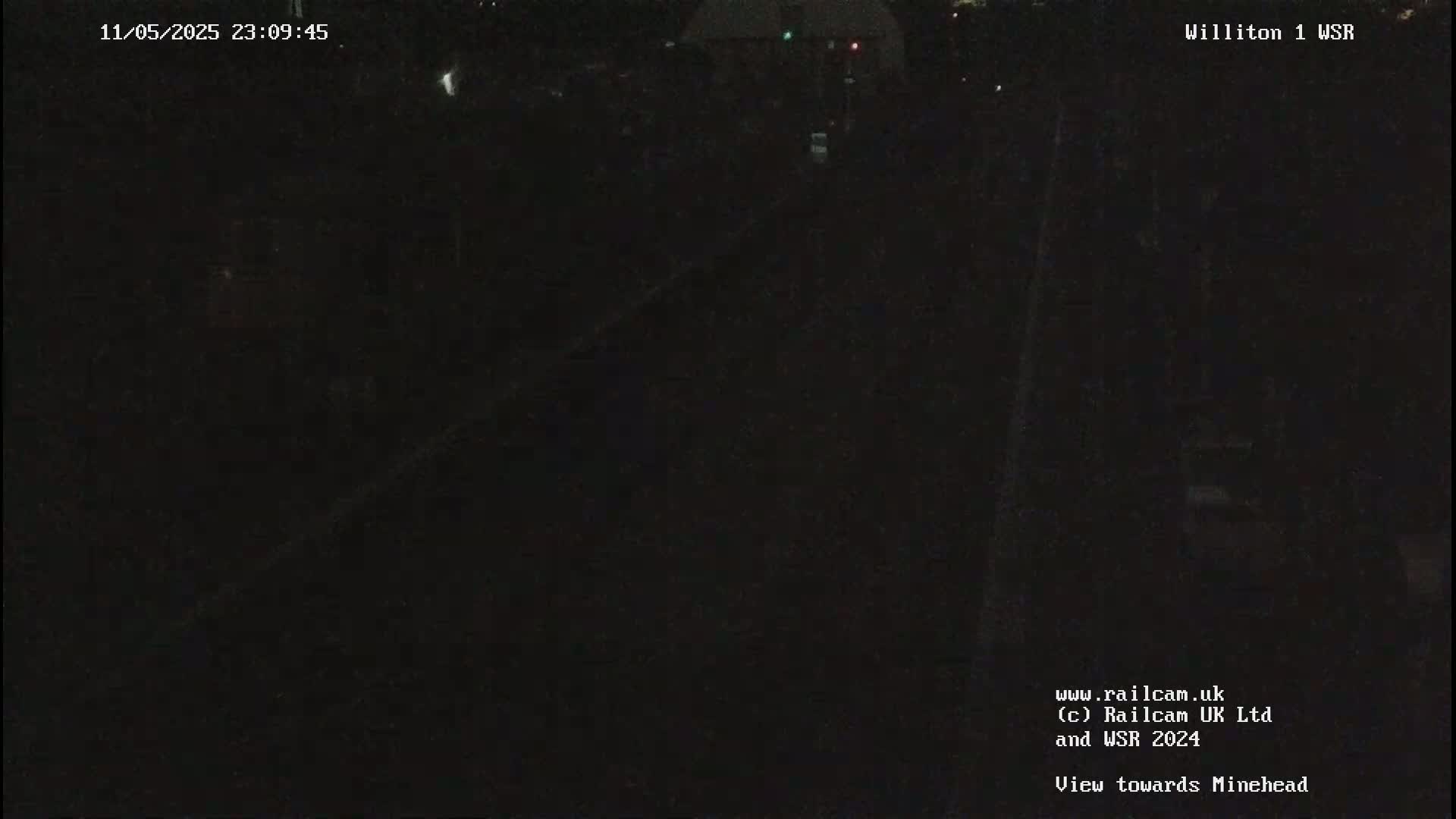 A nighttime view of a dark, possibly wooded area.