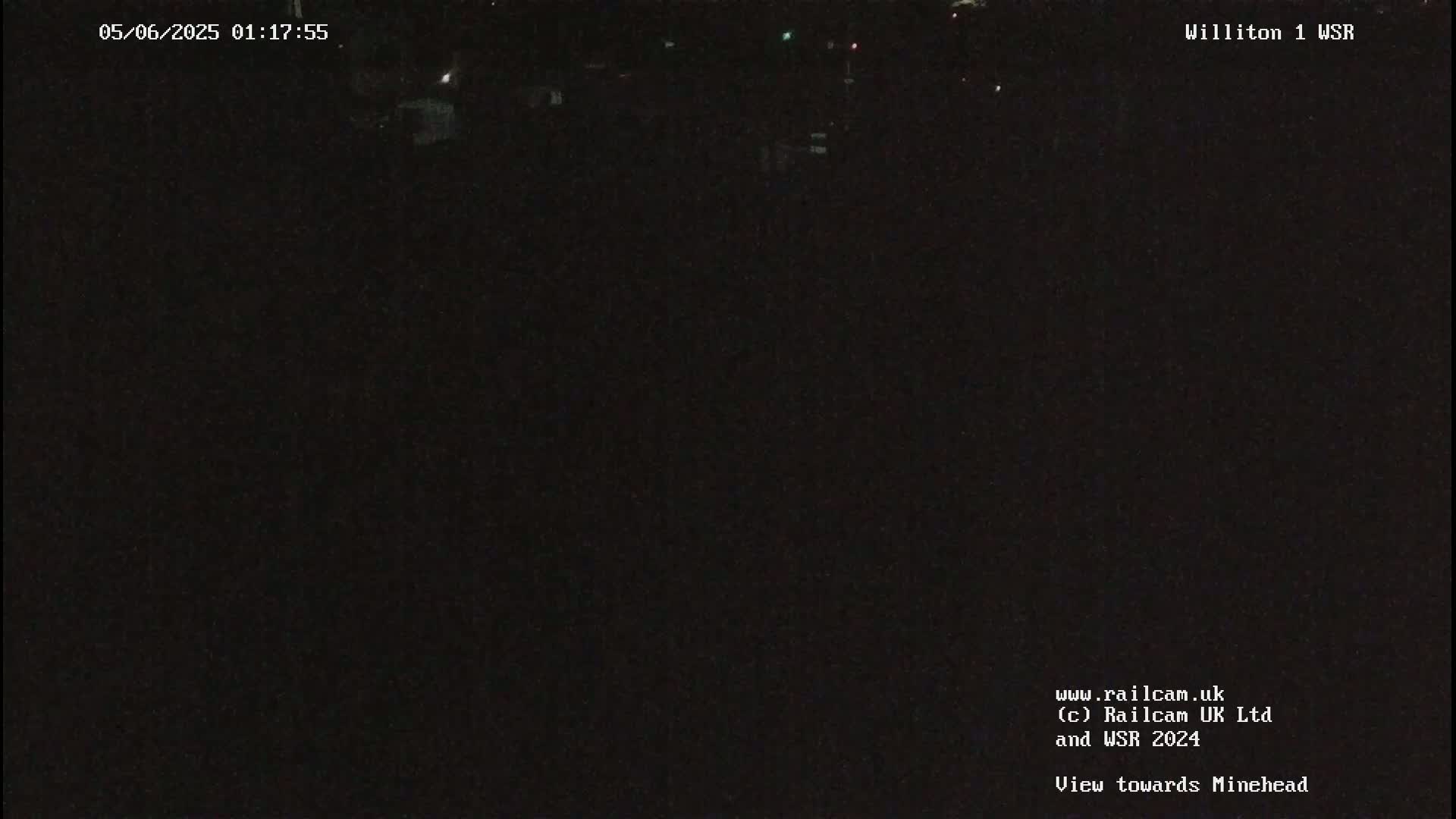 A nighttime view of a dark, indistinct landscape.