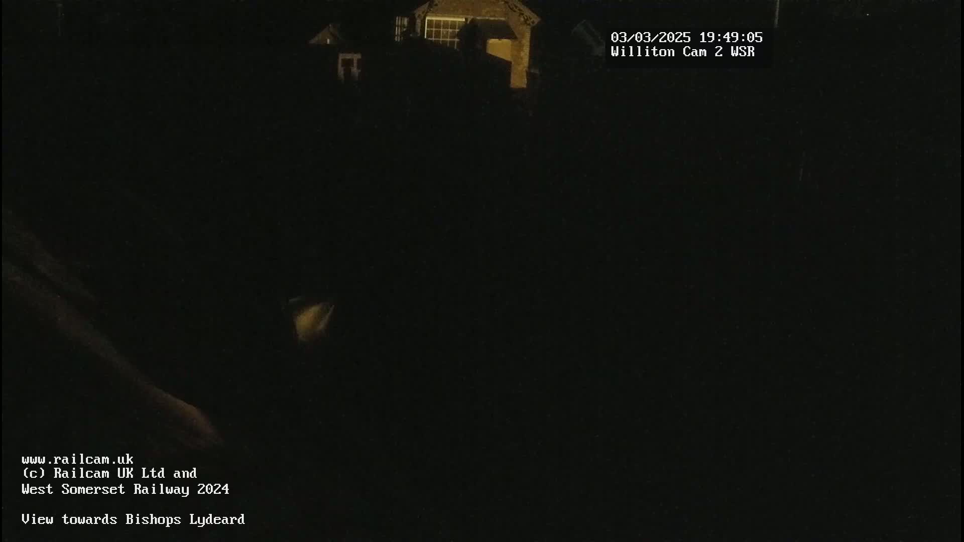 A dark, nighttime view of a building, possibly a house, is shown.