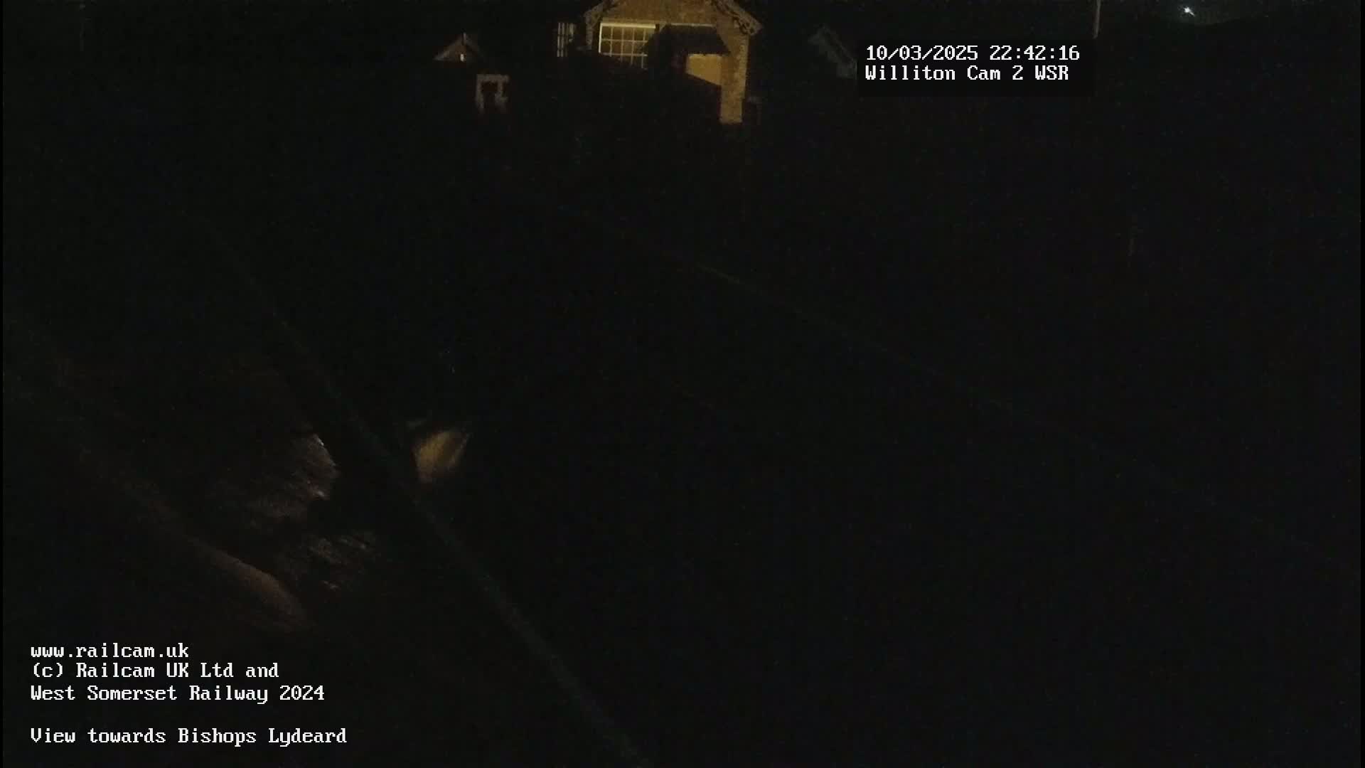 A dark, nighttime view of a building and surrounding area.