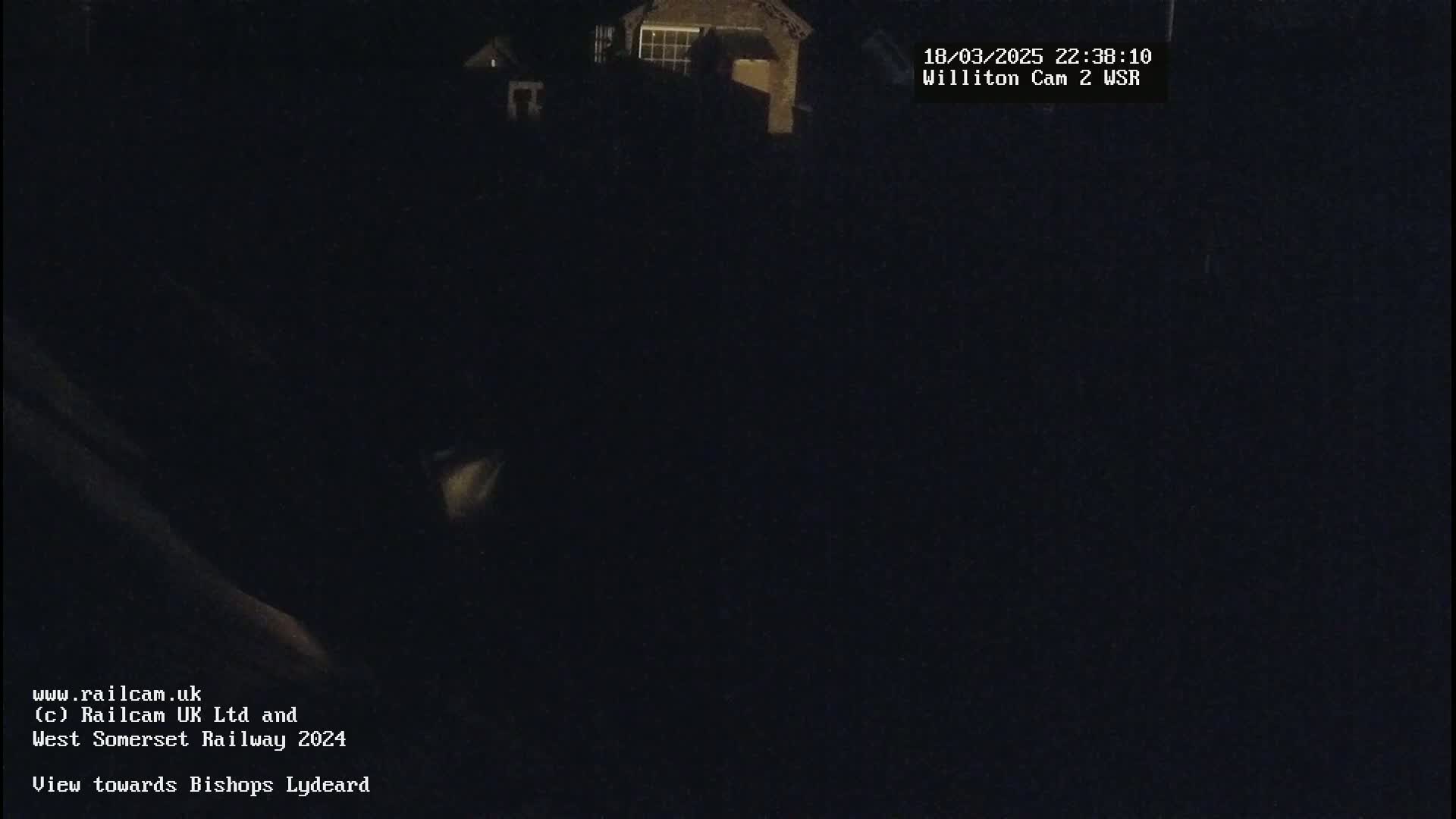 A nighttime, dark view of a building in the distance.