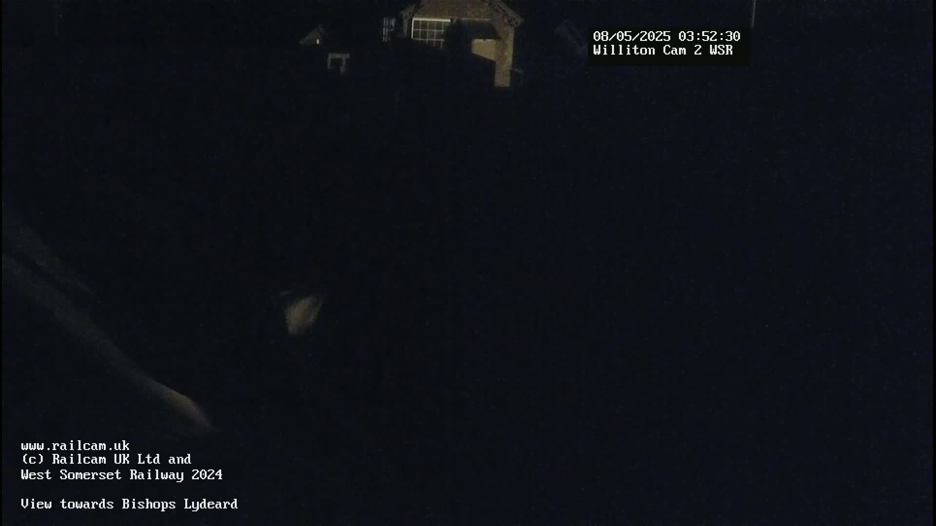 A nighttime, dark view of buildings in the distance.