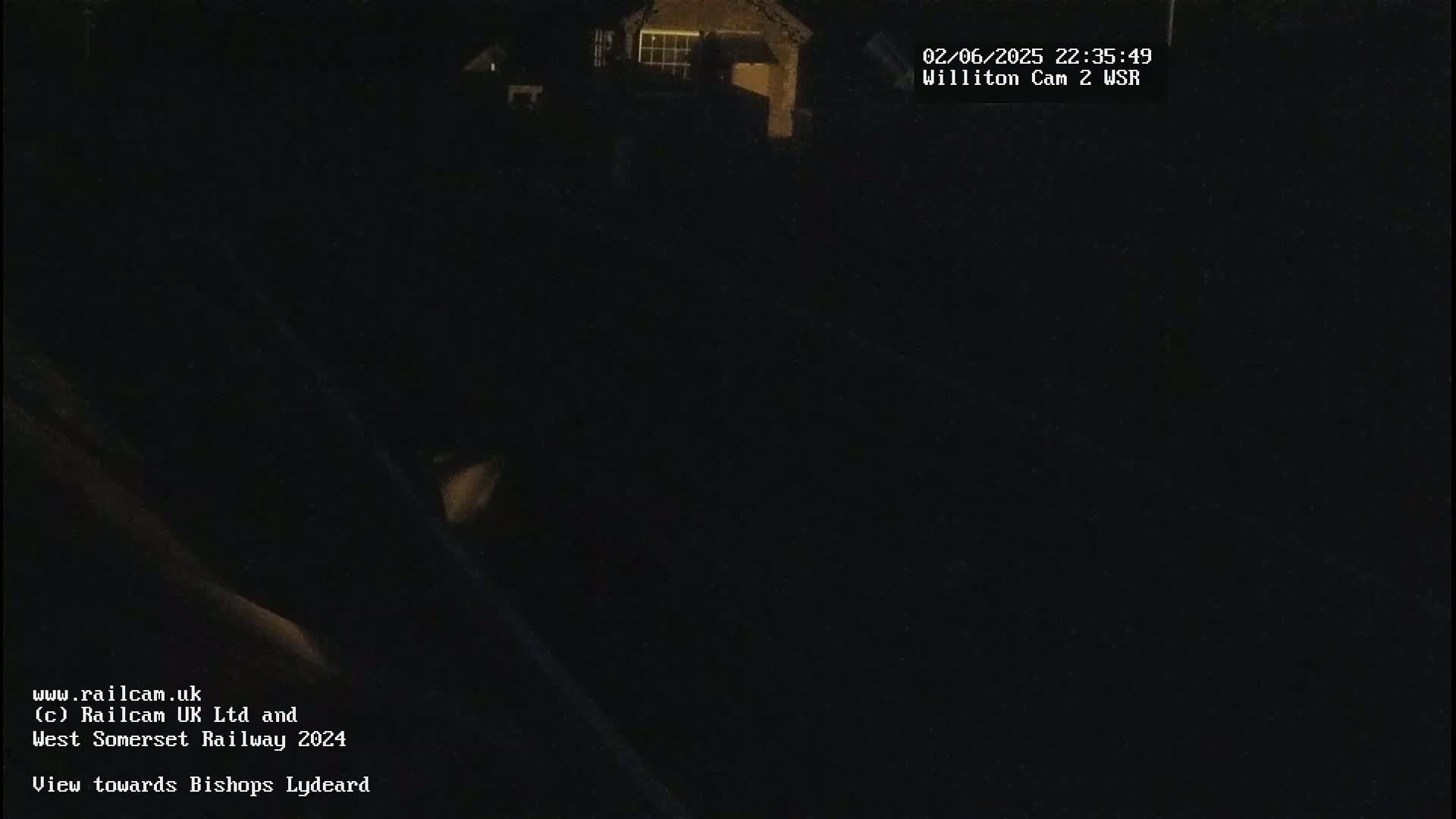 A nighttime, dark view of a building and surrounding area.