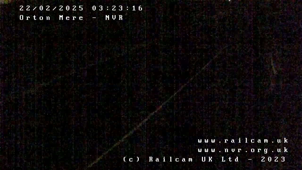 A dark, nighttime image shows a blurry, diagonal line across a mostly black background.