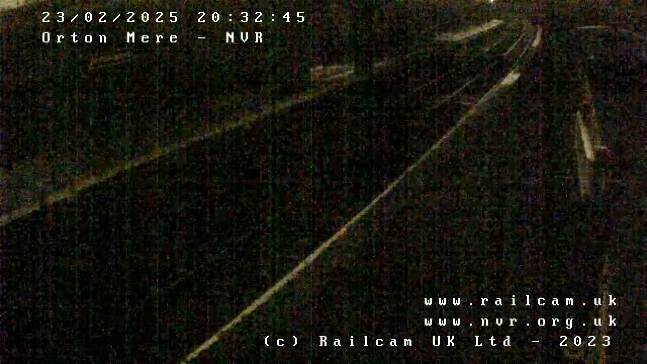 A nighttime, low-light view of railroad tracks.