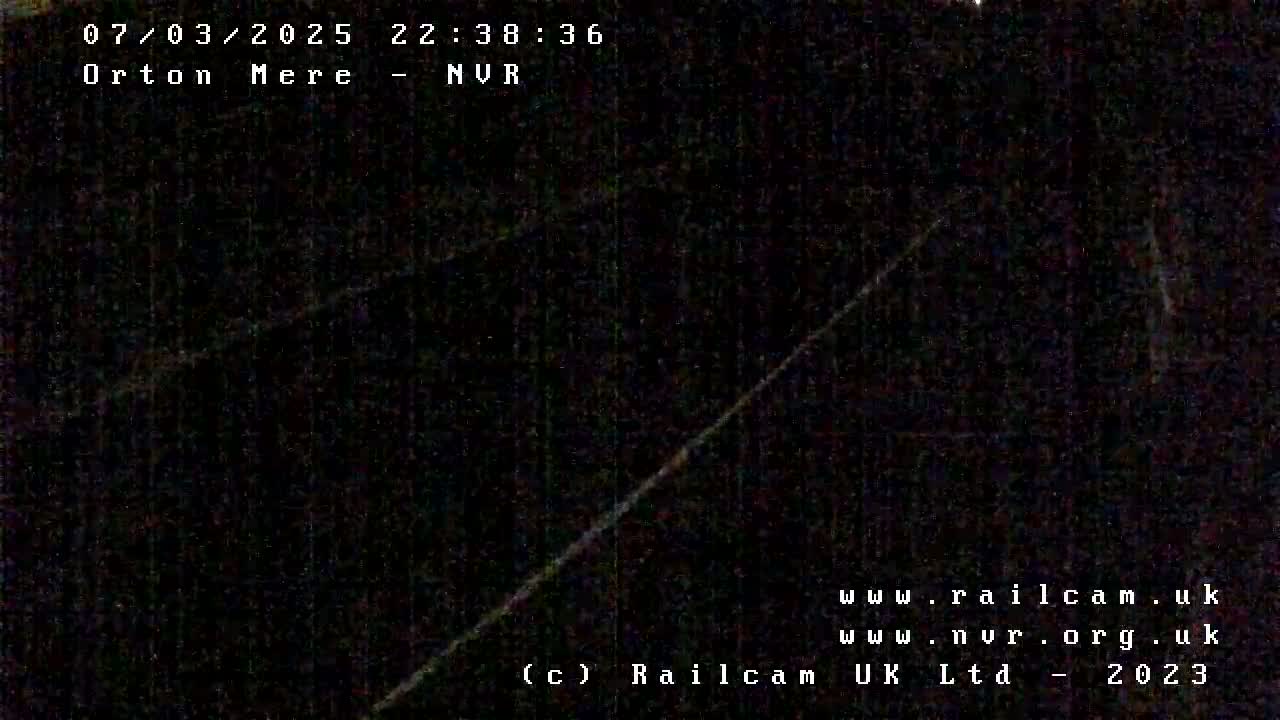A dark, nighttime image shows two diagonal lines against a mostly black background.