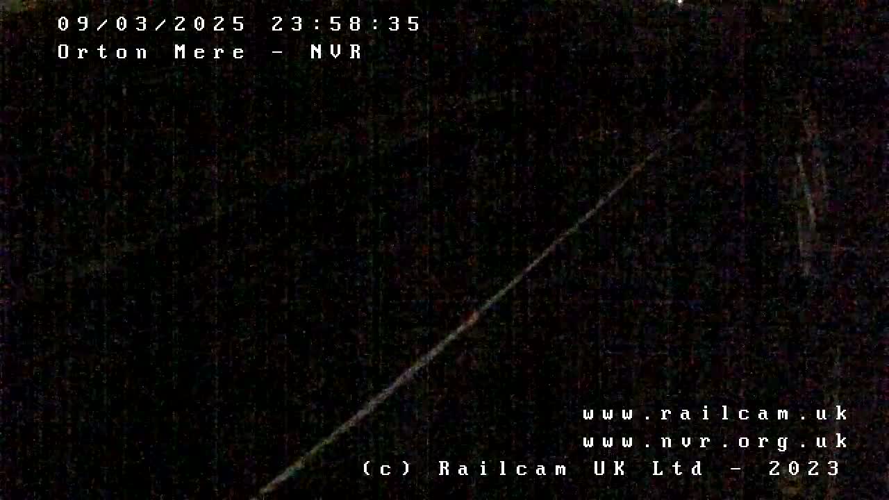 A dark, nighttime image shows a diagonal, bright line against a mostly black background.