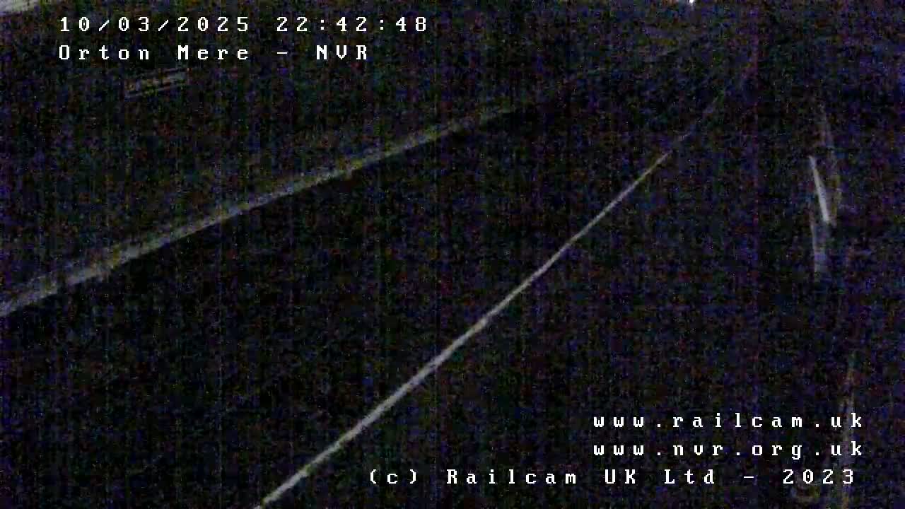 A dimly lit nighttime view of train tracks.