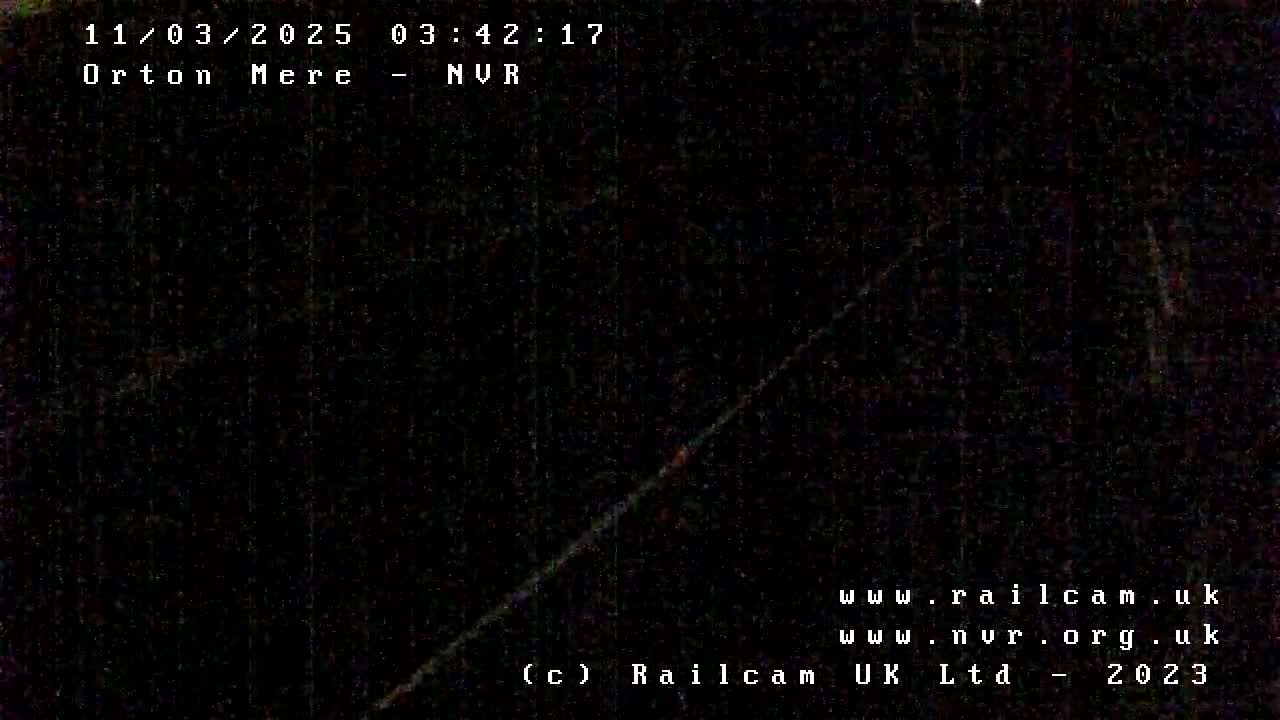 A nighttime, dark image shows a diagonal line of light across a completely black background.
