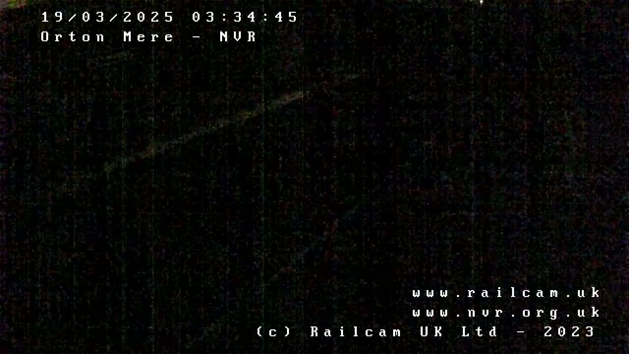 A very dark, nighttime image shows an indiscernible scene.